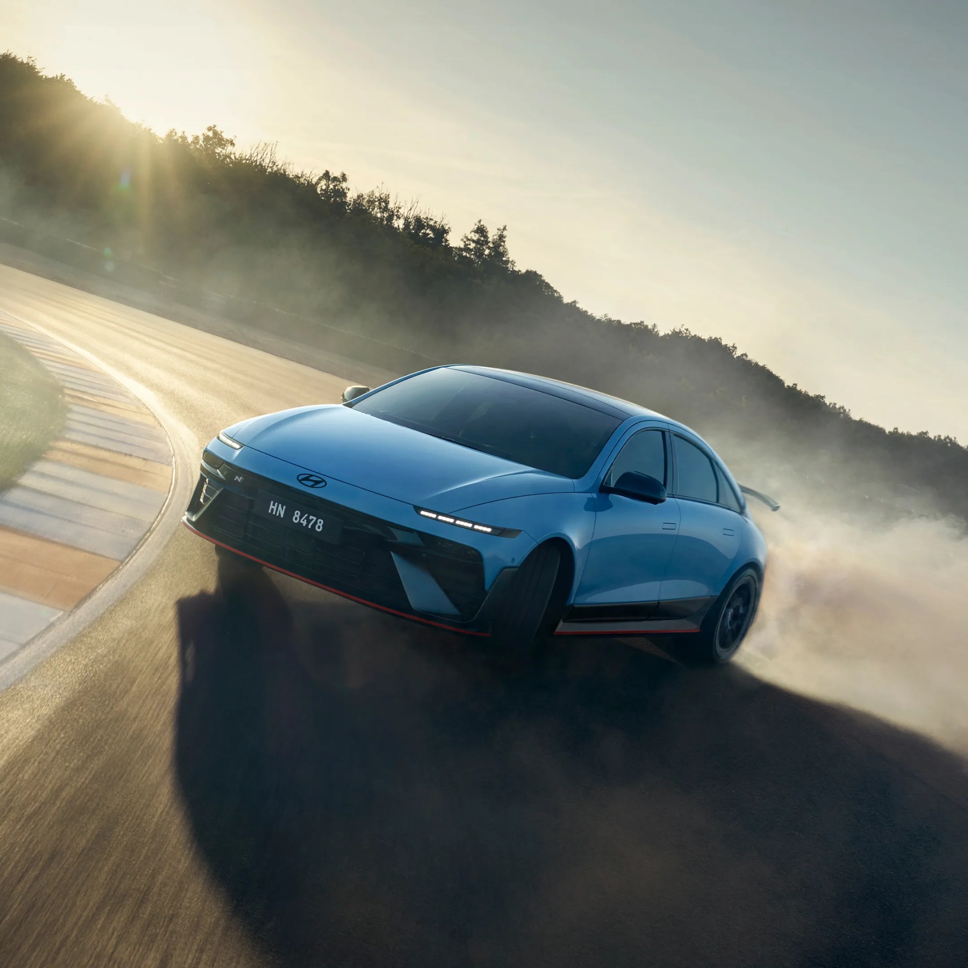 Hyundai Ioniq 6 N Sport Sedan drifting around race track corner in morning