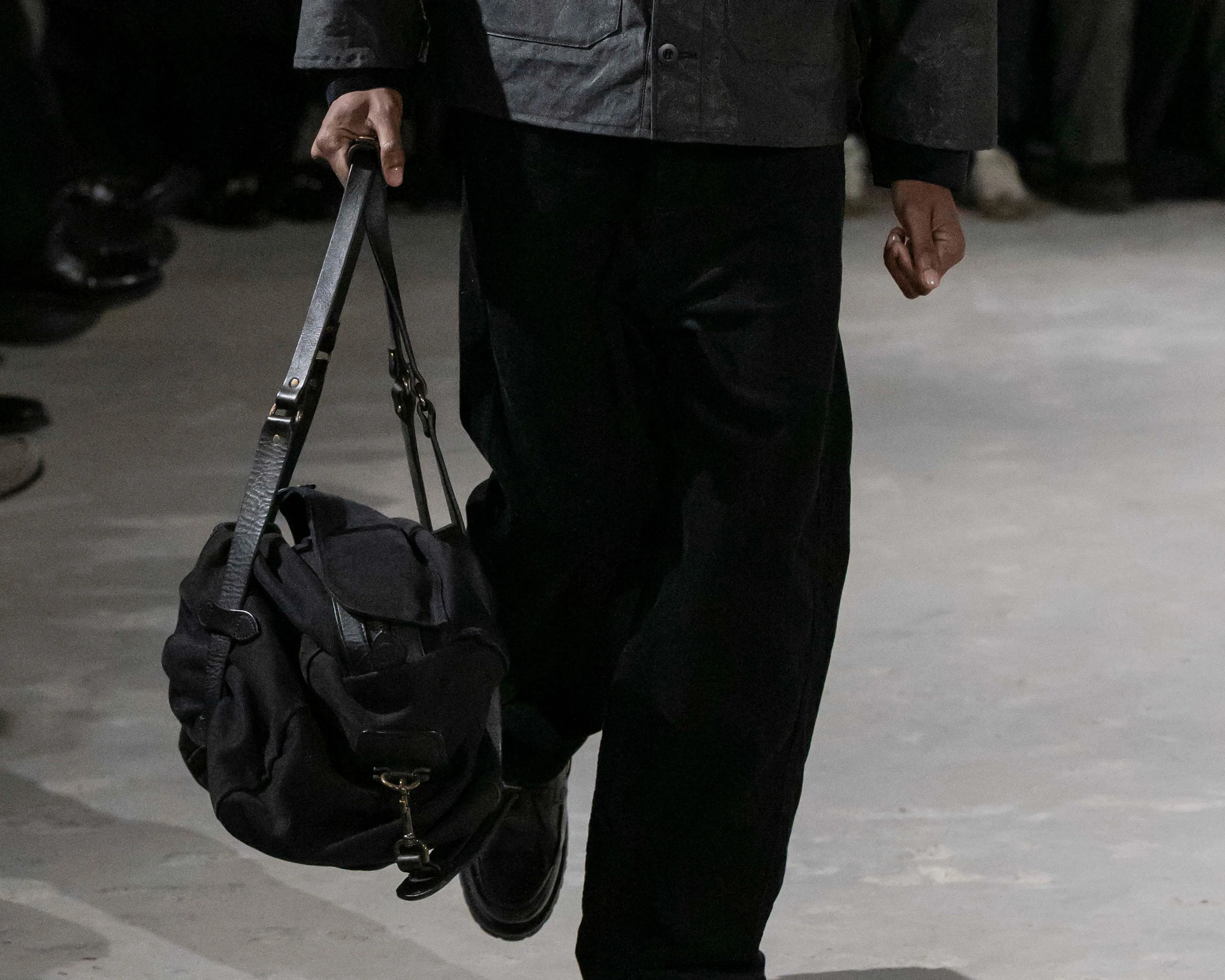 a man carrying a Filson bag