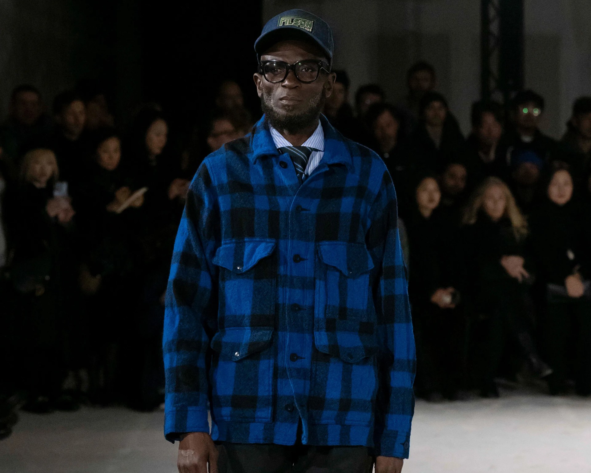 a man in a blue Filson Junya Watanabe Man mackinaw jacket