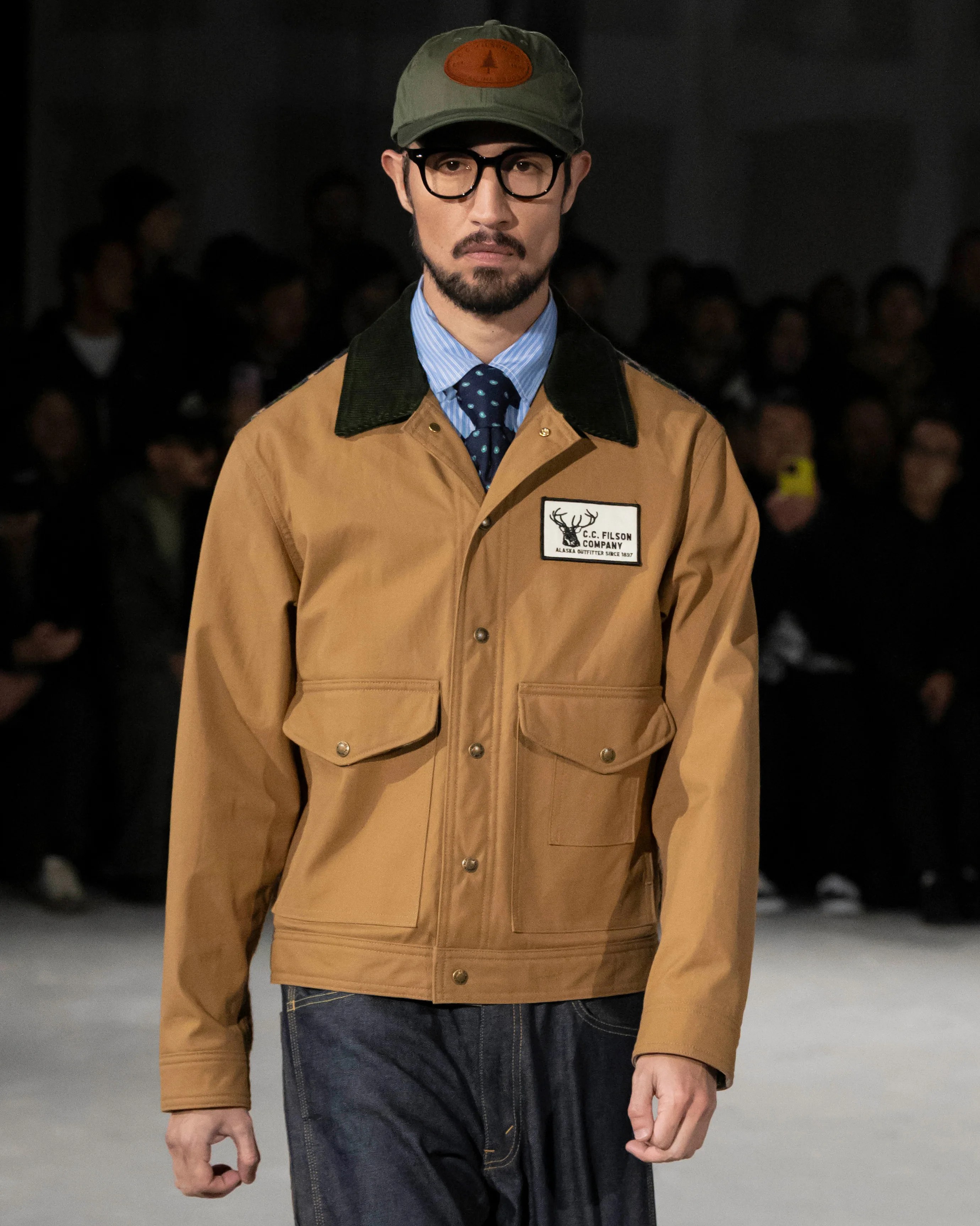 a man in a Filson jacket and hat