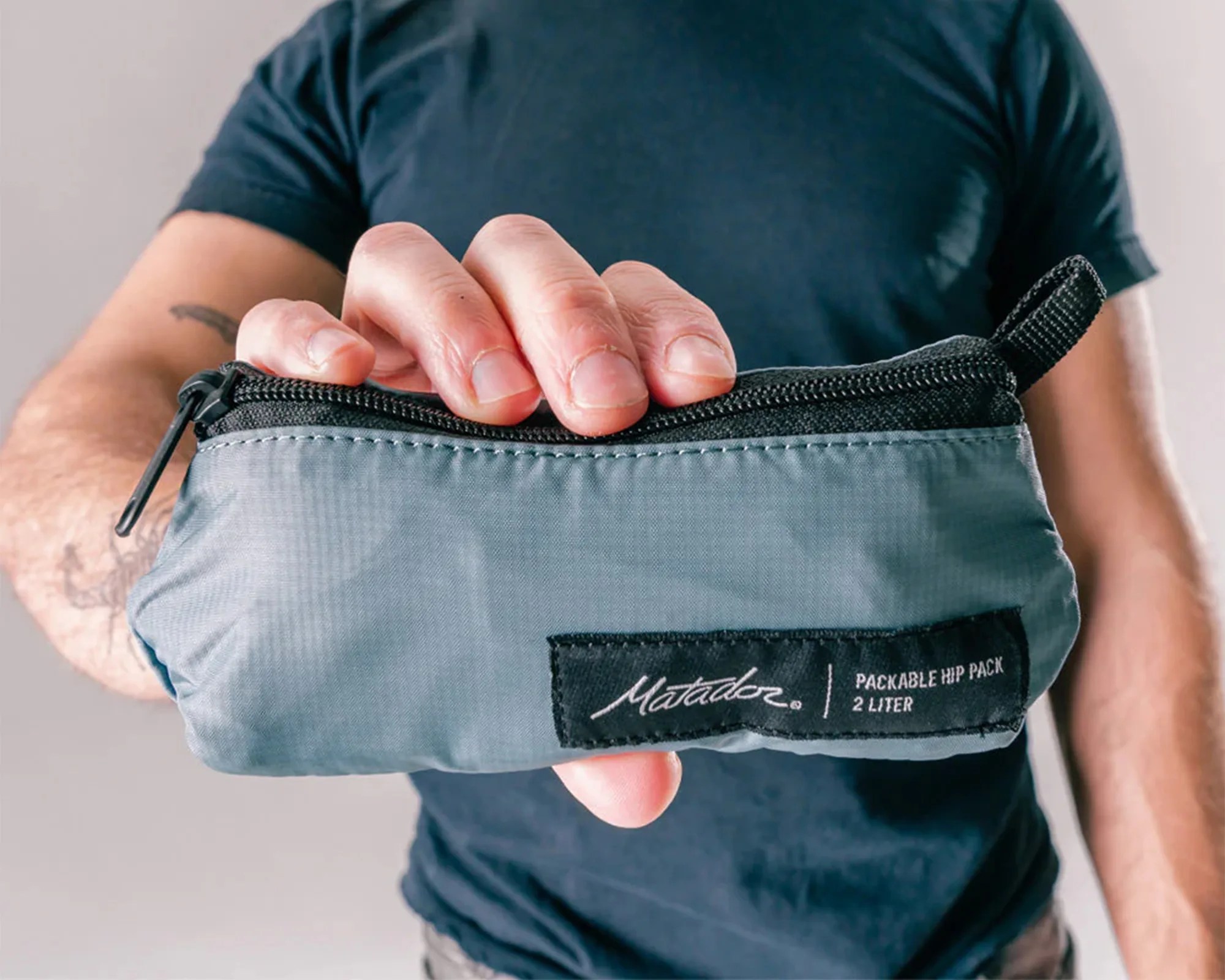 Matador ReFraction Packable Sling packed up and held in hand