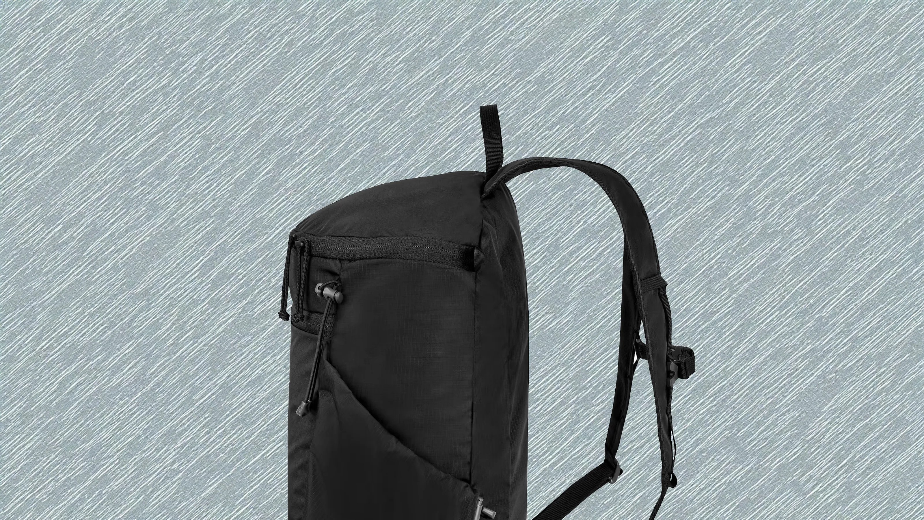 Mystery Ranch In and out Packable Backpack 18L in black shown in profile against a light grey textured background
