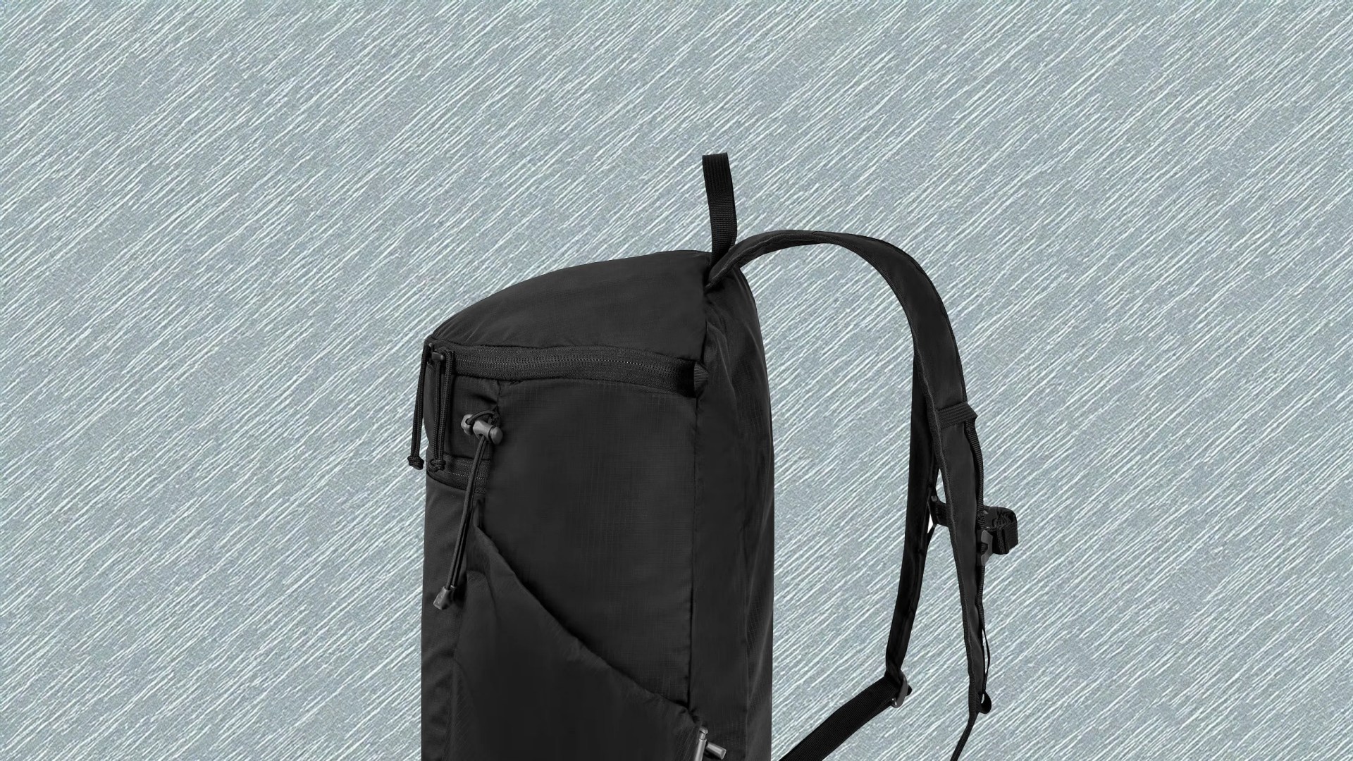 Mystery Ranch In and out Packable Backpack 18L in black shown in profile against a light grey textured background