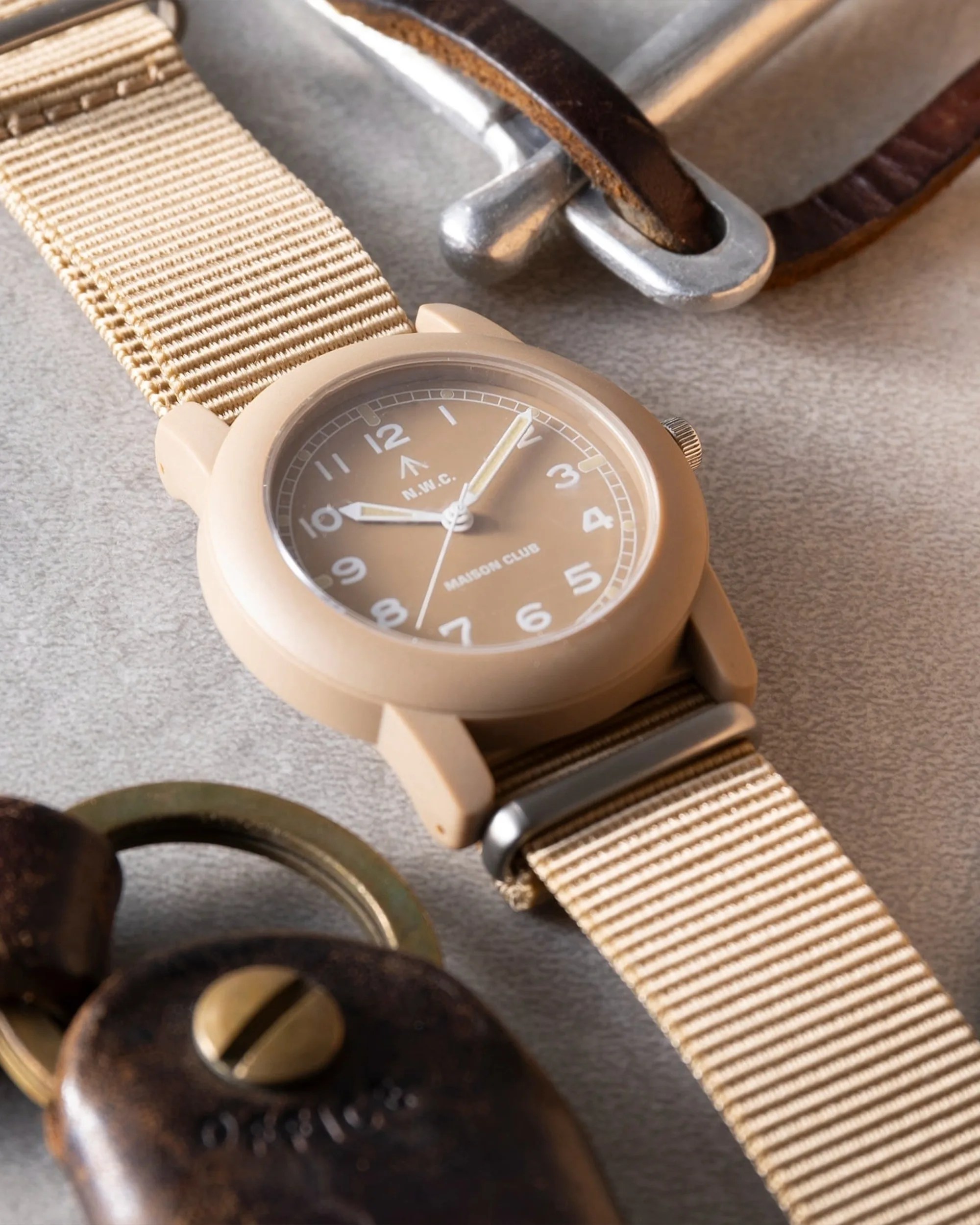Naval Watch x Maison Club Mil 08 Field Watch tan on table with EDC items