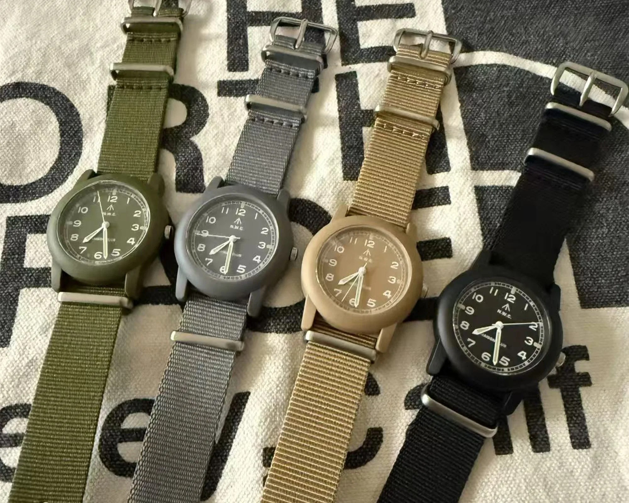 Naval Watch x Maison Club Mil 08 Field Watch family on The North Face canvas