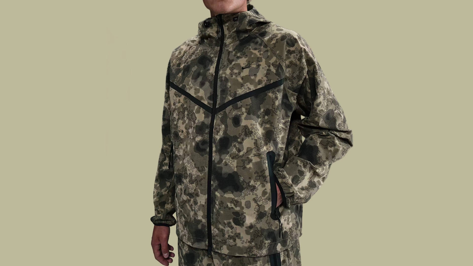 A model shown wearing a camo Nike jump suit