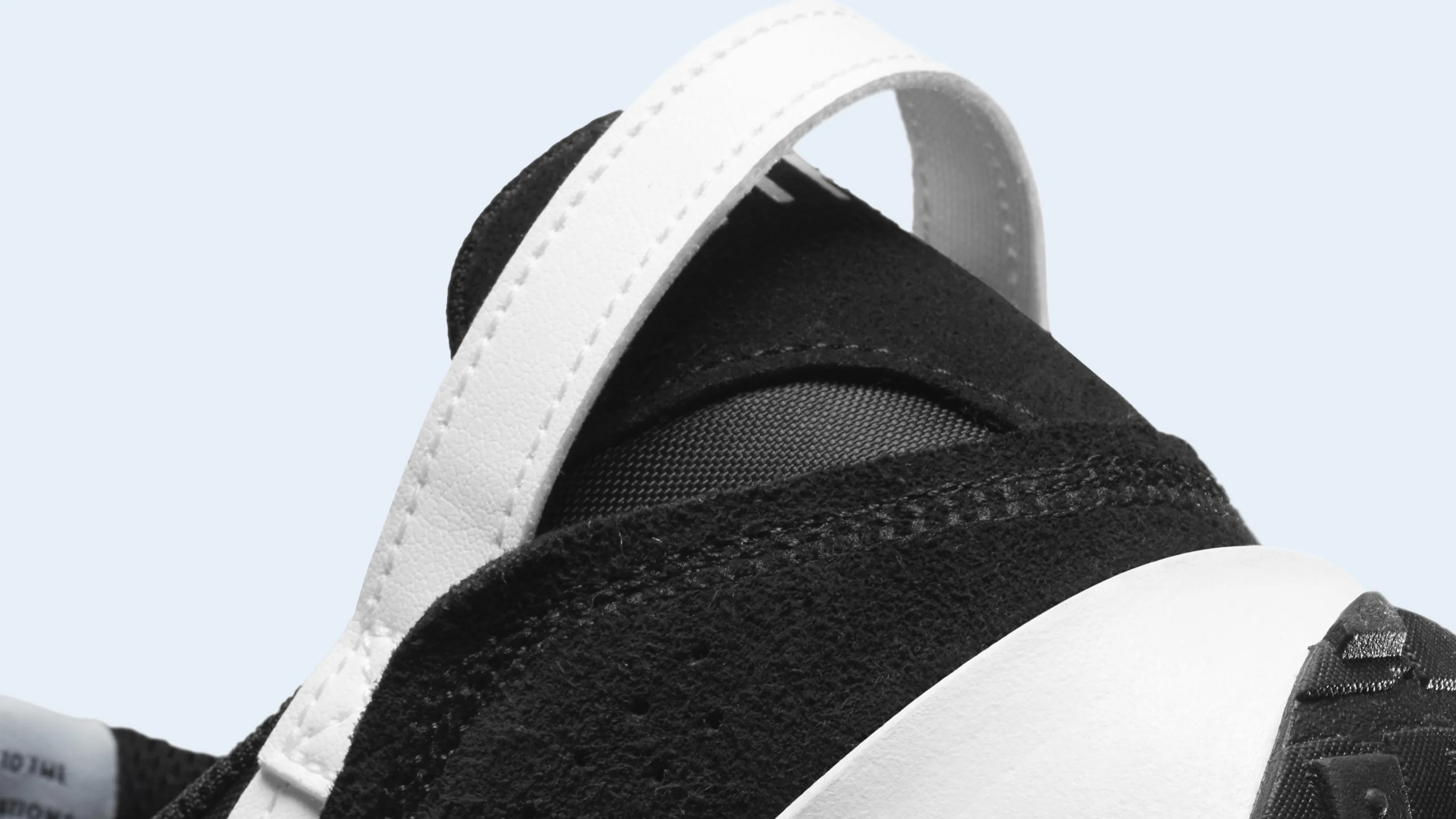 A close-up of the hell of the Nike Waffle Debut sneaker in black