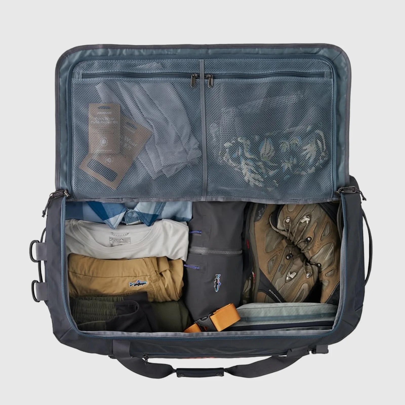 A Patagonia Black Hole Duffle shown with the lid zipped open to reveal in the interior