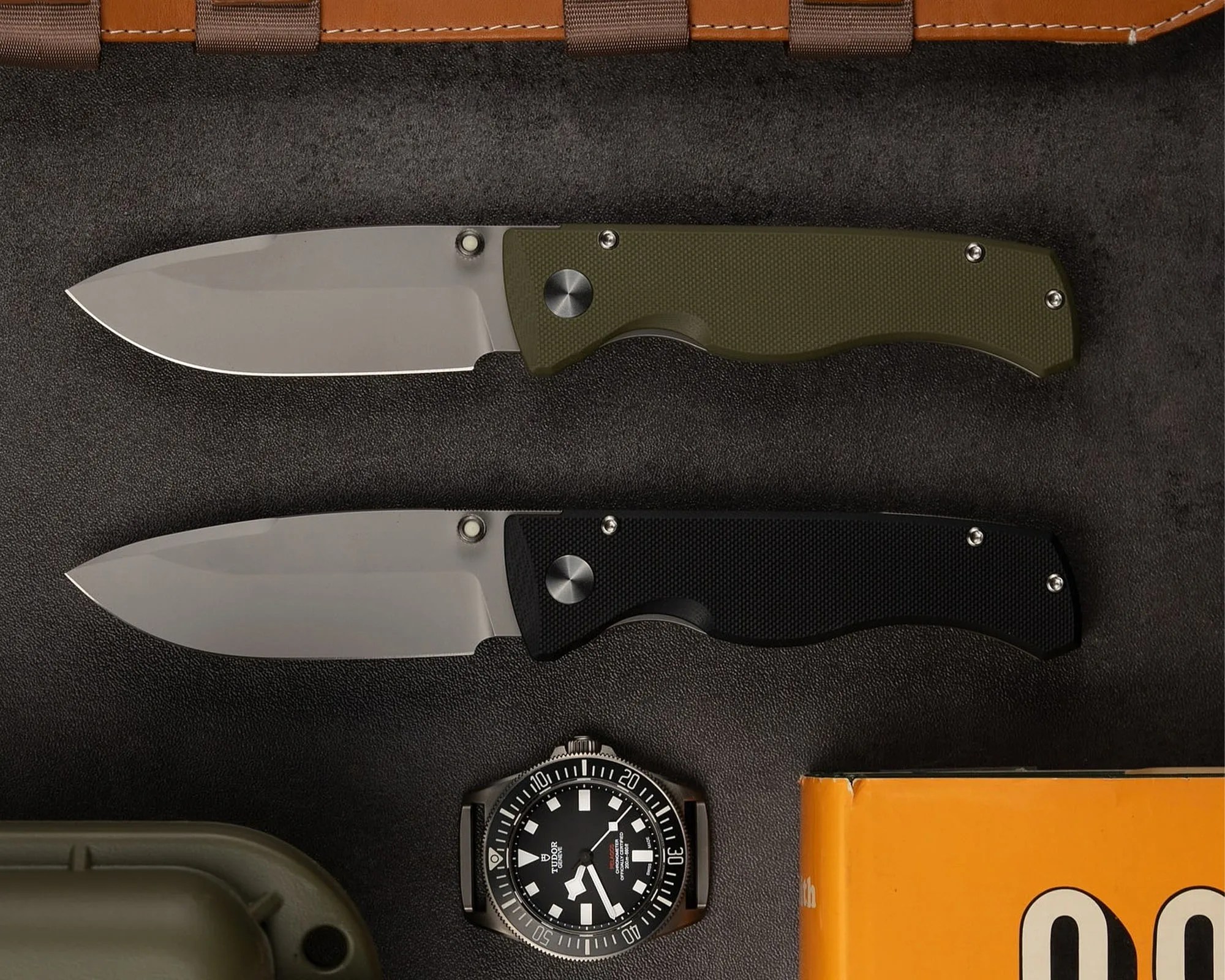 Prometheus Design Werx x Watches of Espionage Birdwatcher knives with other gear on black background