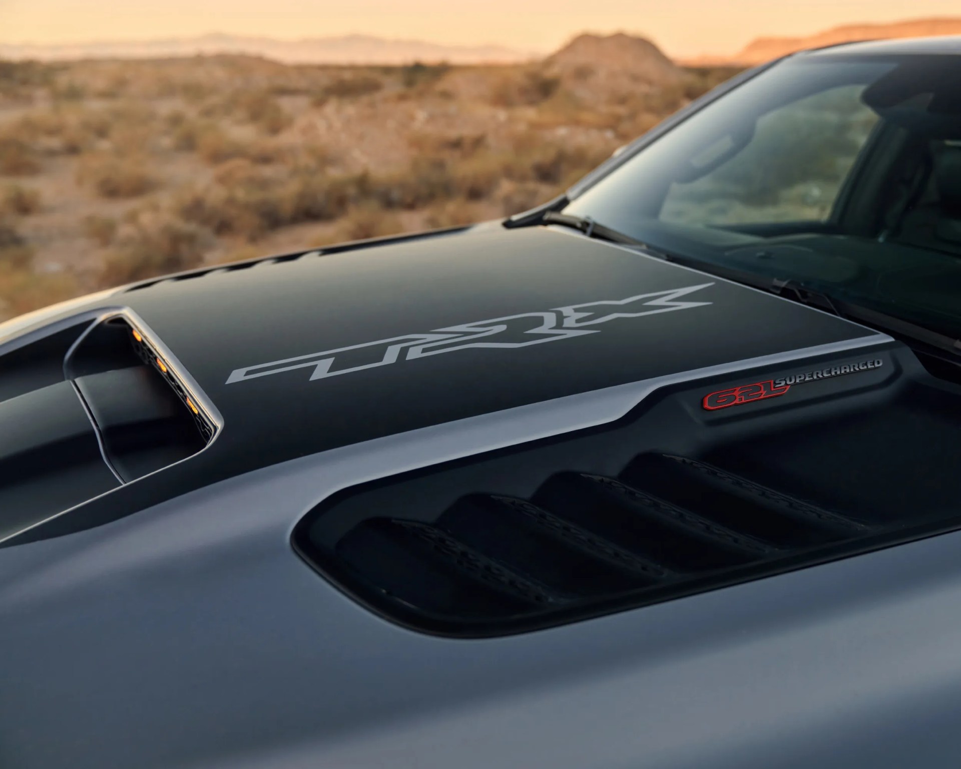 close-up shot of ram trx pickup truck with mountain backdrop
