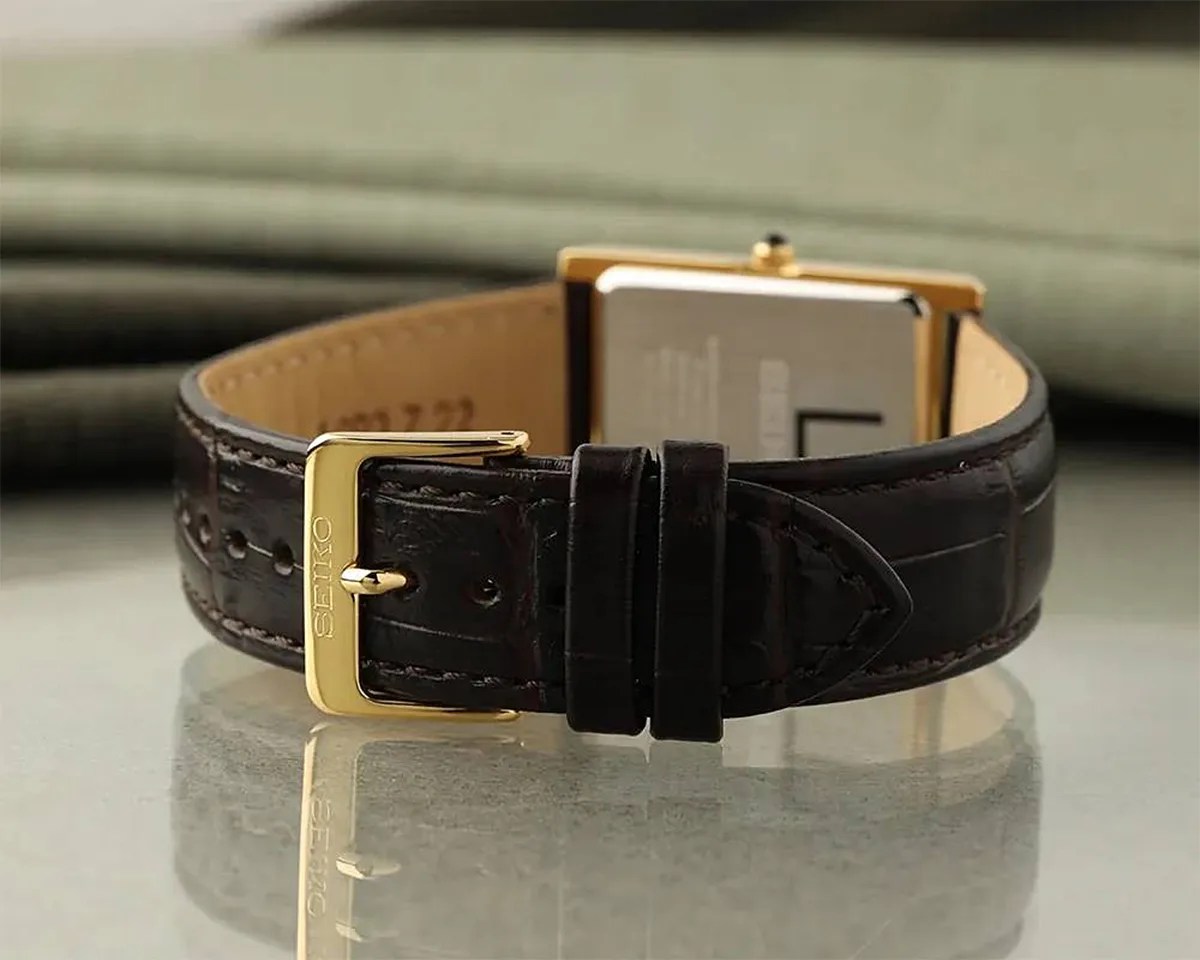 the band of a gold Seiko dress watch