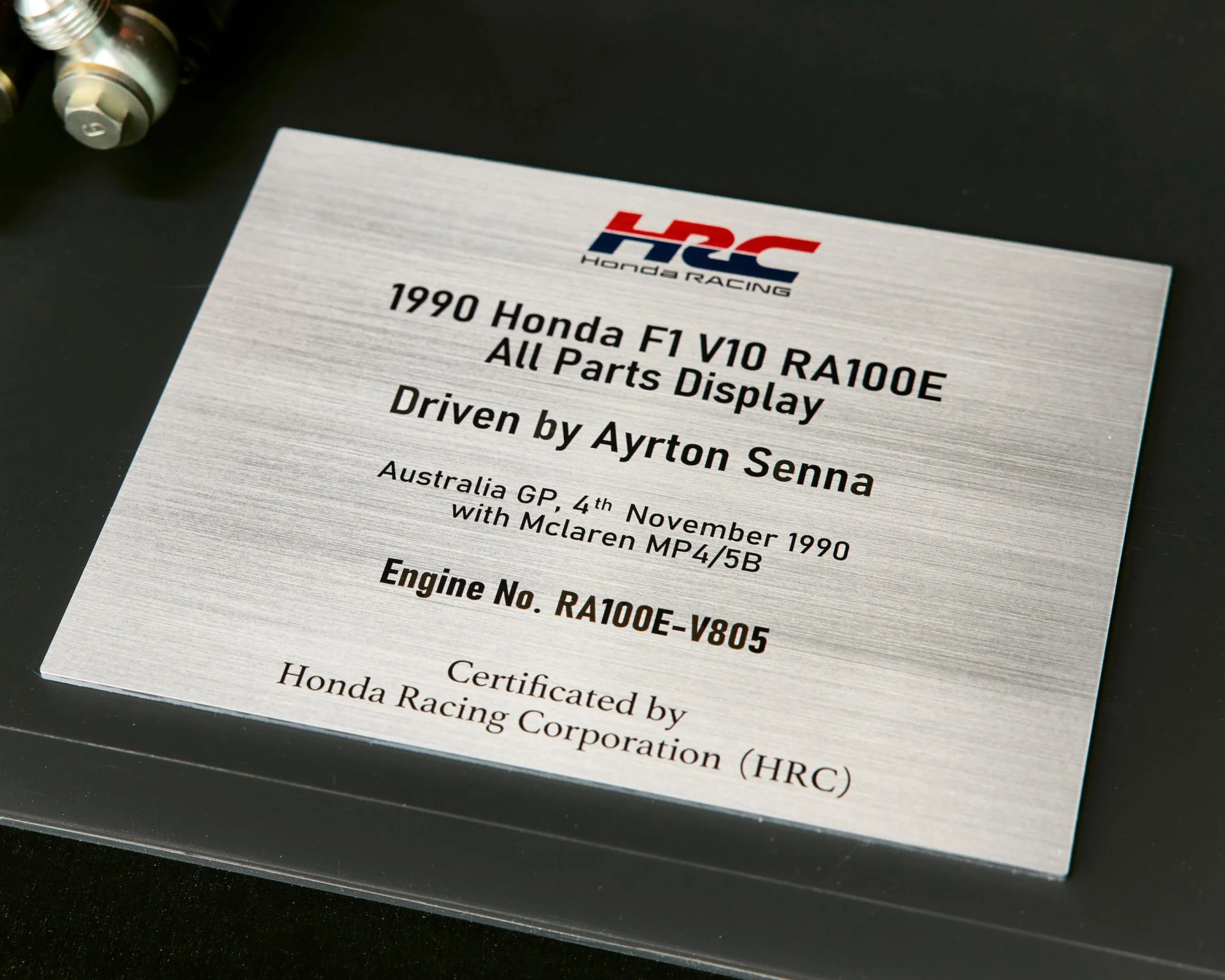close-up of a plaque for the last ayrton senna v10 honda engine