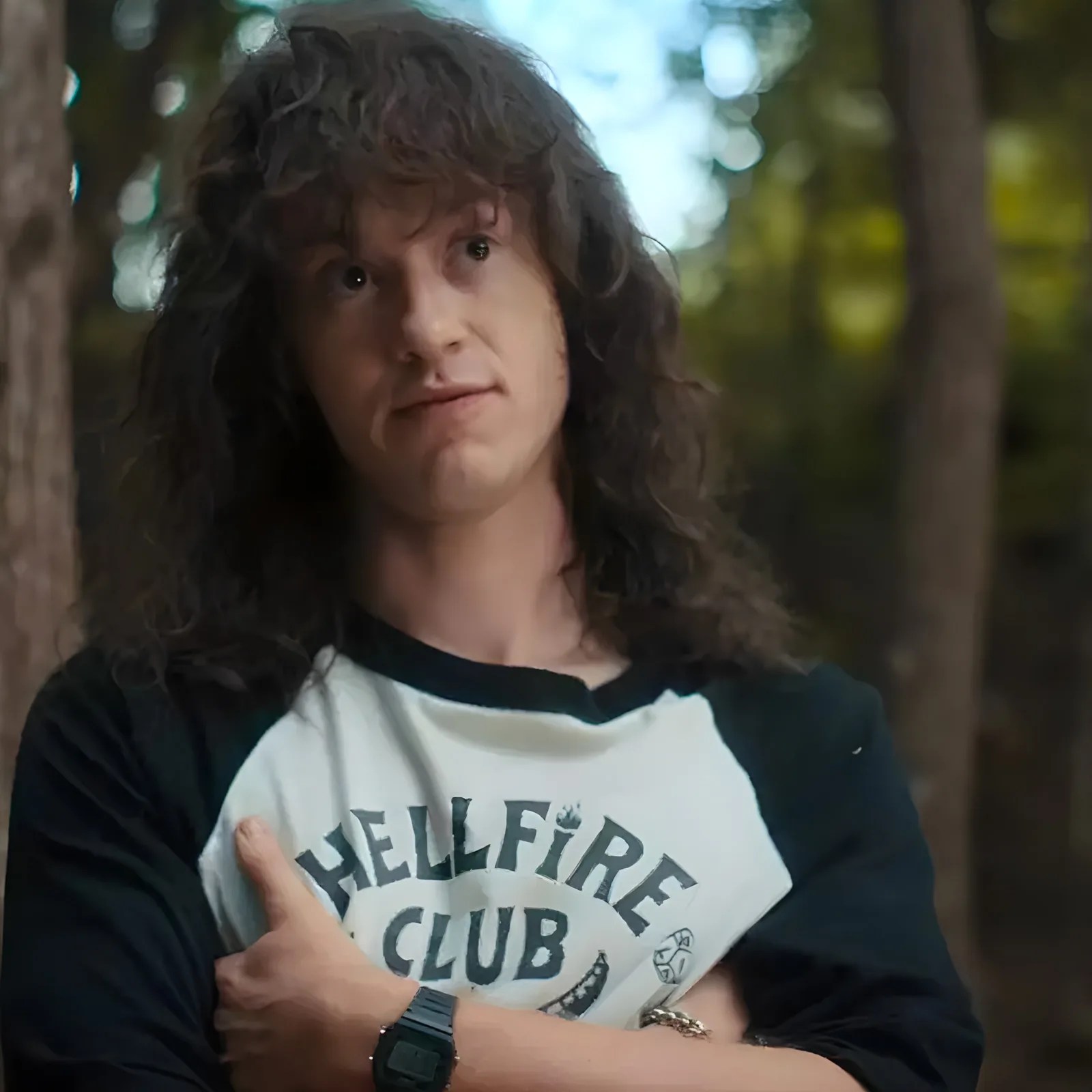 A screenshot from the Netflix TV show Stranger Things showing the character Eddie Munson wearing a Casio digital watch with his arms crossed