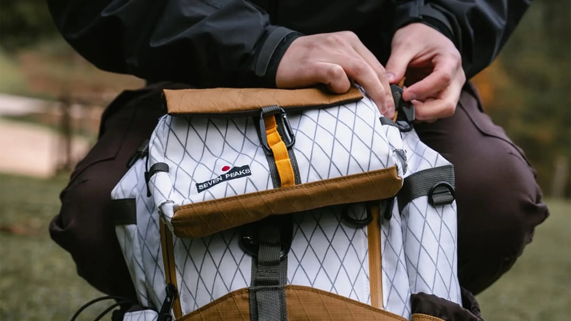 Seven Peaks All Versions Backpack closeup with person outdoors