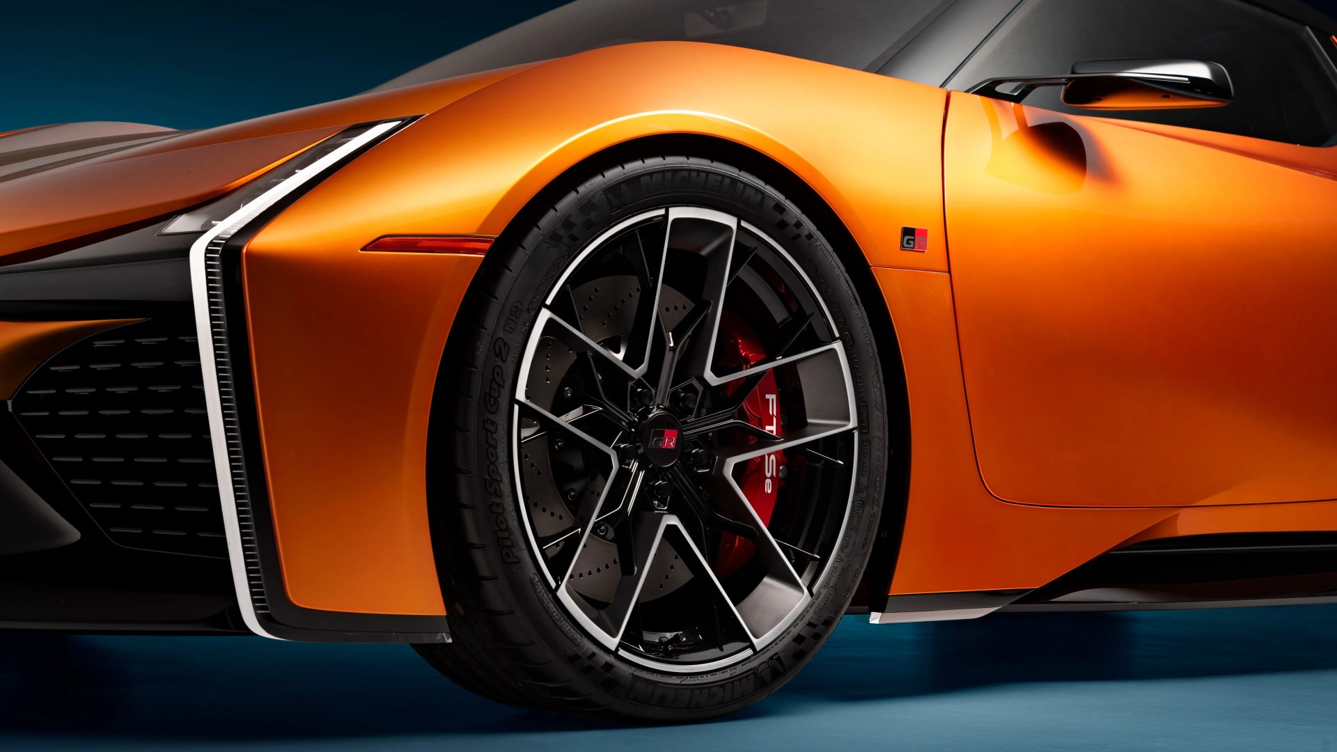 a close-up shot of an orange toyota concept car wheel
