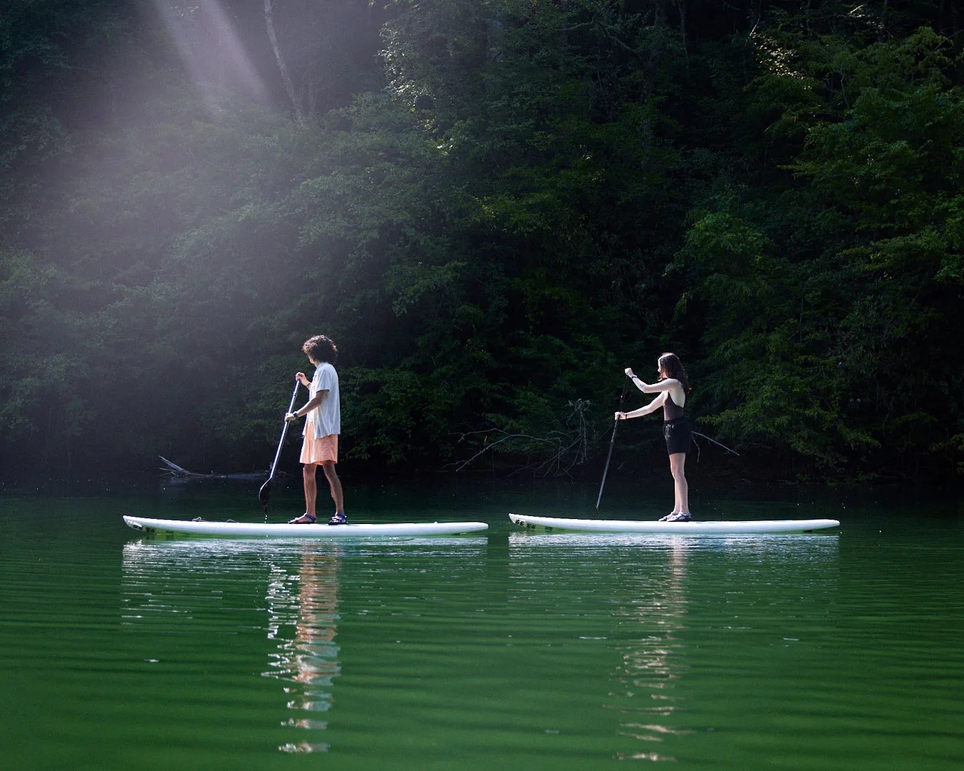 two people stand up paddling at fontana lake