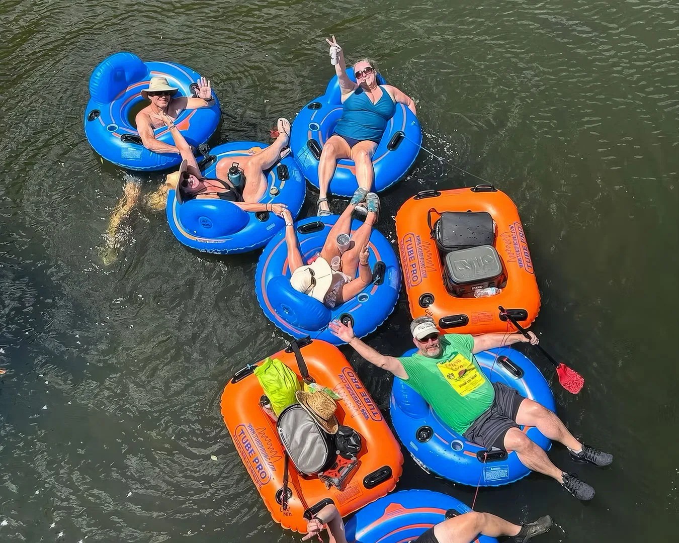 a group of individuals floating in tubes on a river