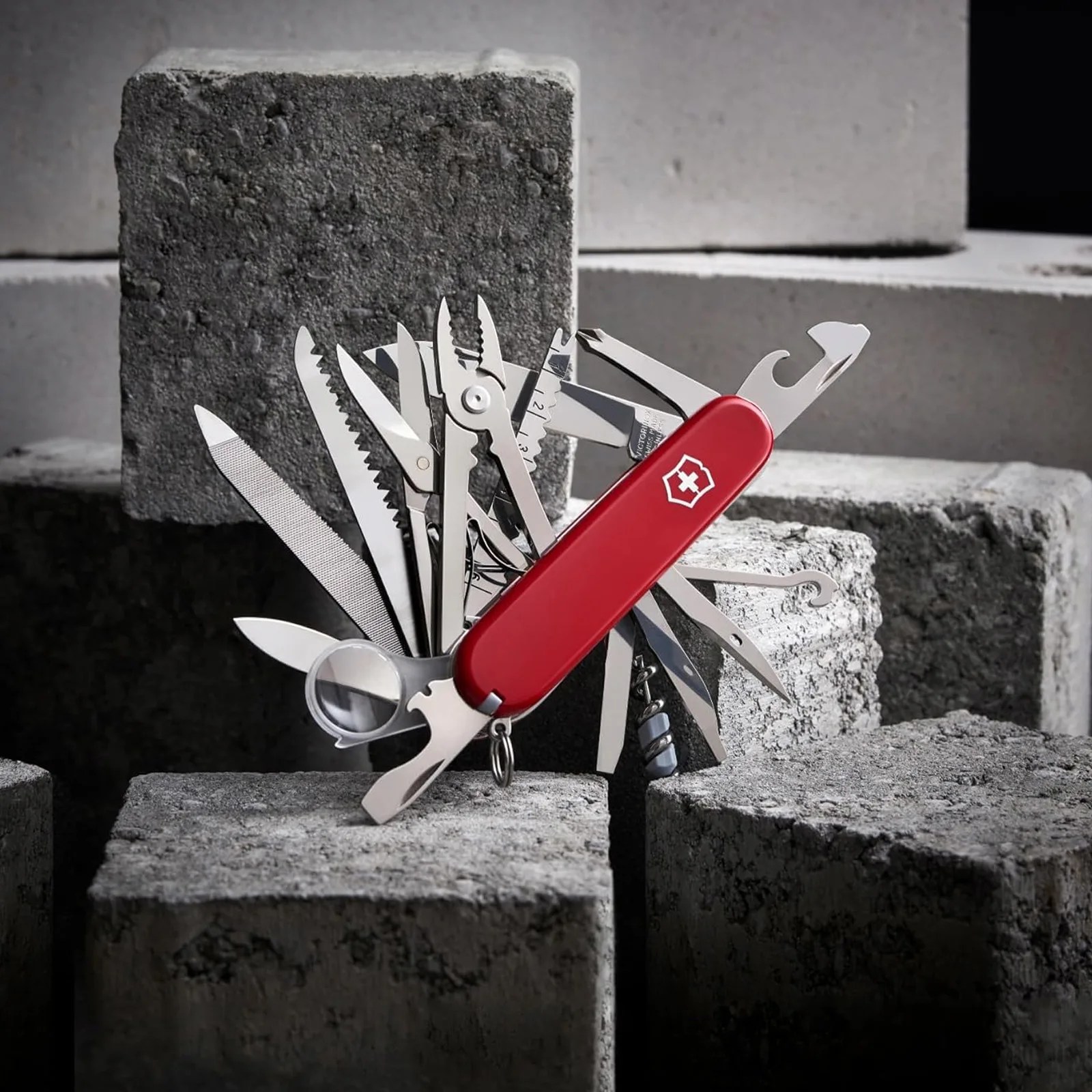 The Victorinox Champ Multi-tool shown with all the tools open resting on concrete blocks.