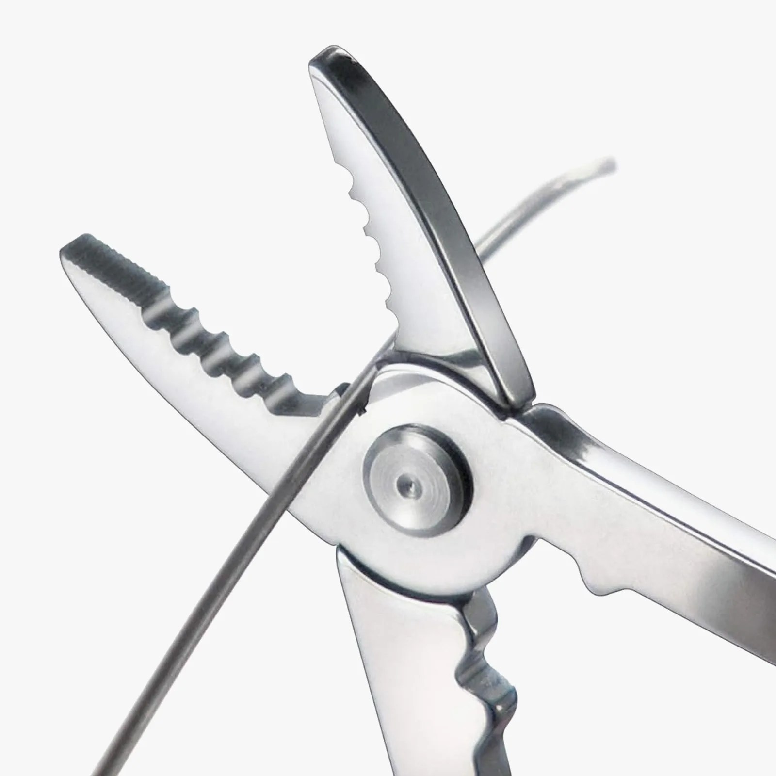 A close up of the pliers included on the Victorinox Champ shown cutting a metal wire