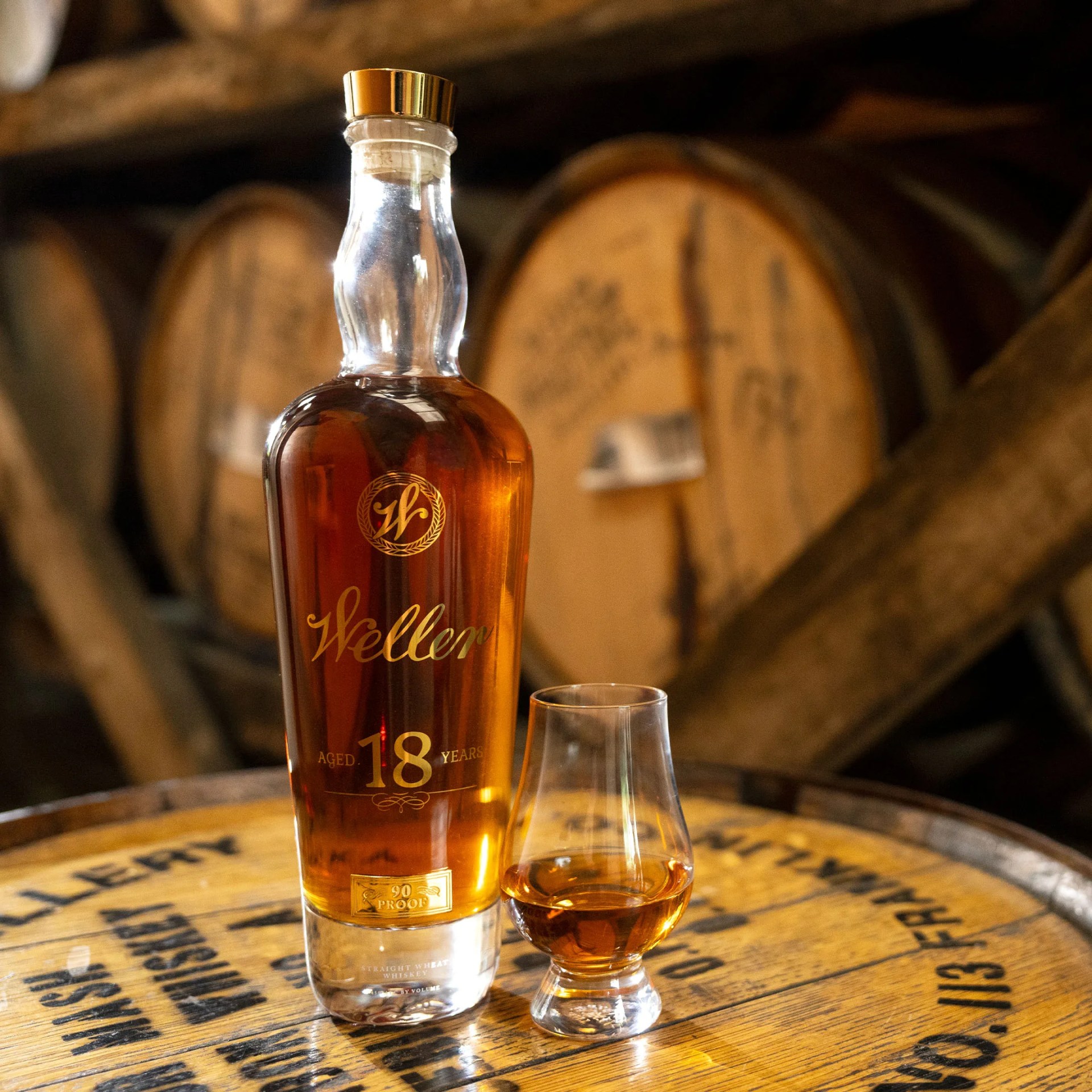 a bottle and glass of weller bourbon