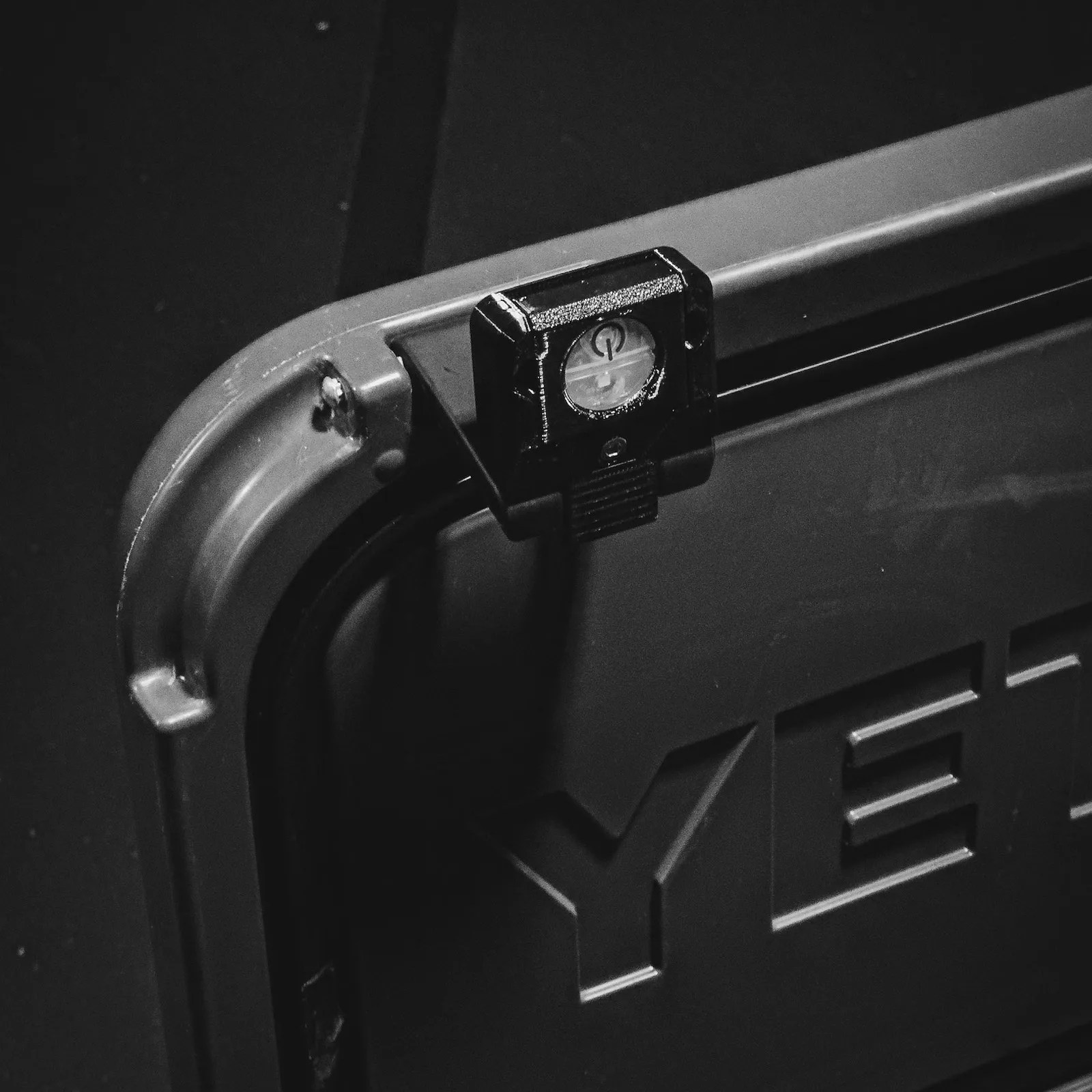 LatchOutdoors Latch Light shown attached to a grey Yeti Roadie Cooler up close