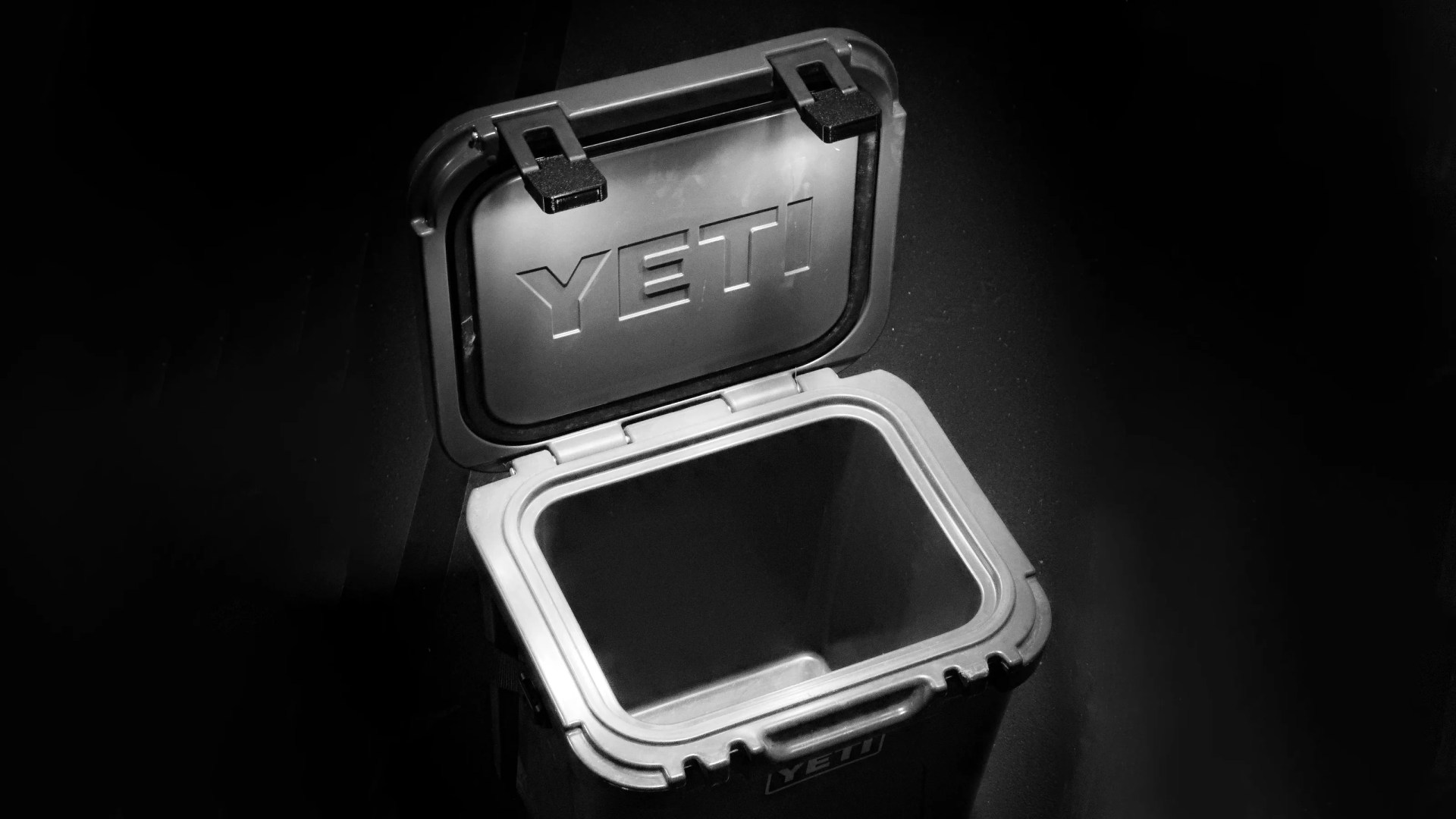 LatchOutdoors Latch Lights shown lighting up a grey Yeti cooler with the lid open