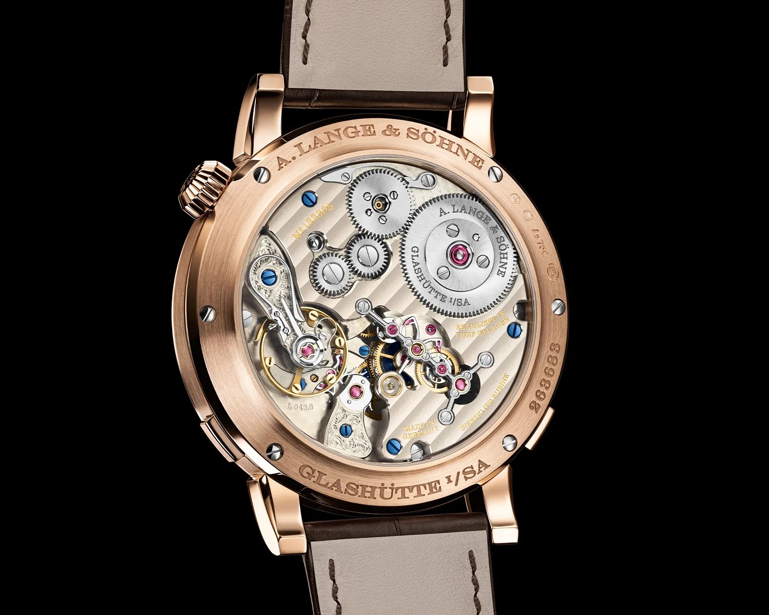 the mechanical movement of an a lange and sohne watch seen through its caseback