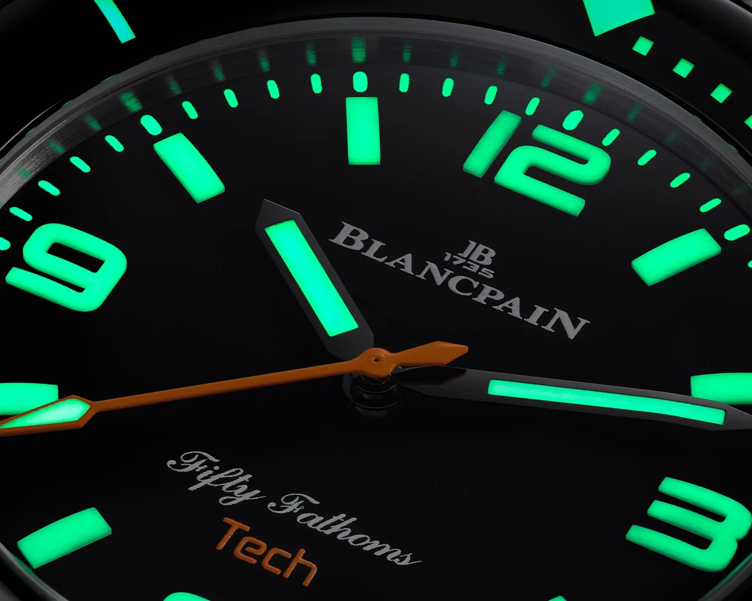 a closeup of a a Blancpain dive watch dial glowing in the dark