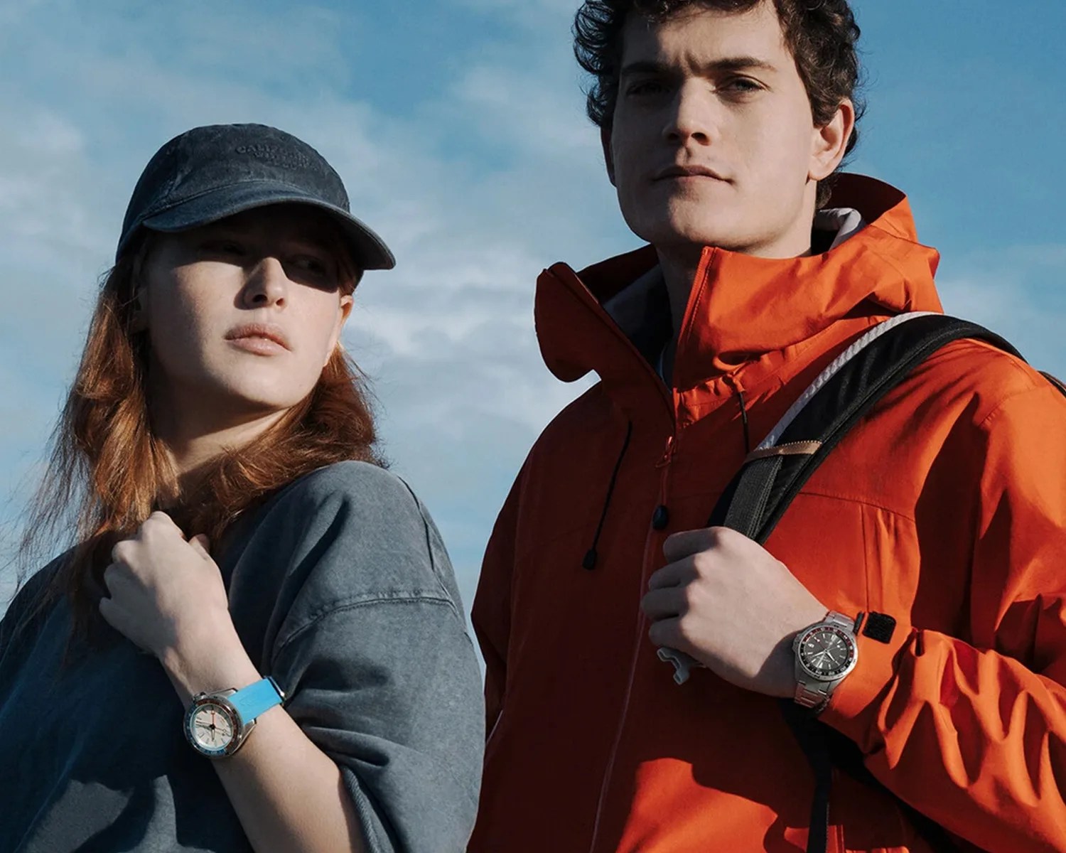 a man and woman in outdoor gear wearing Certina watches
