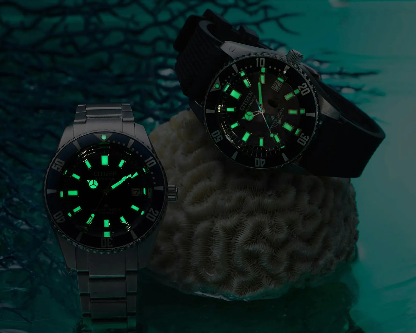 two Citizen watches in the dark