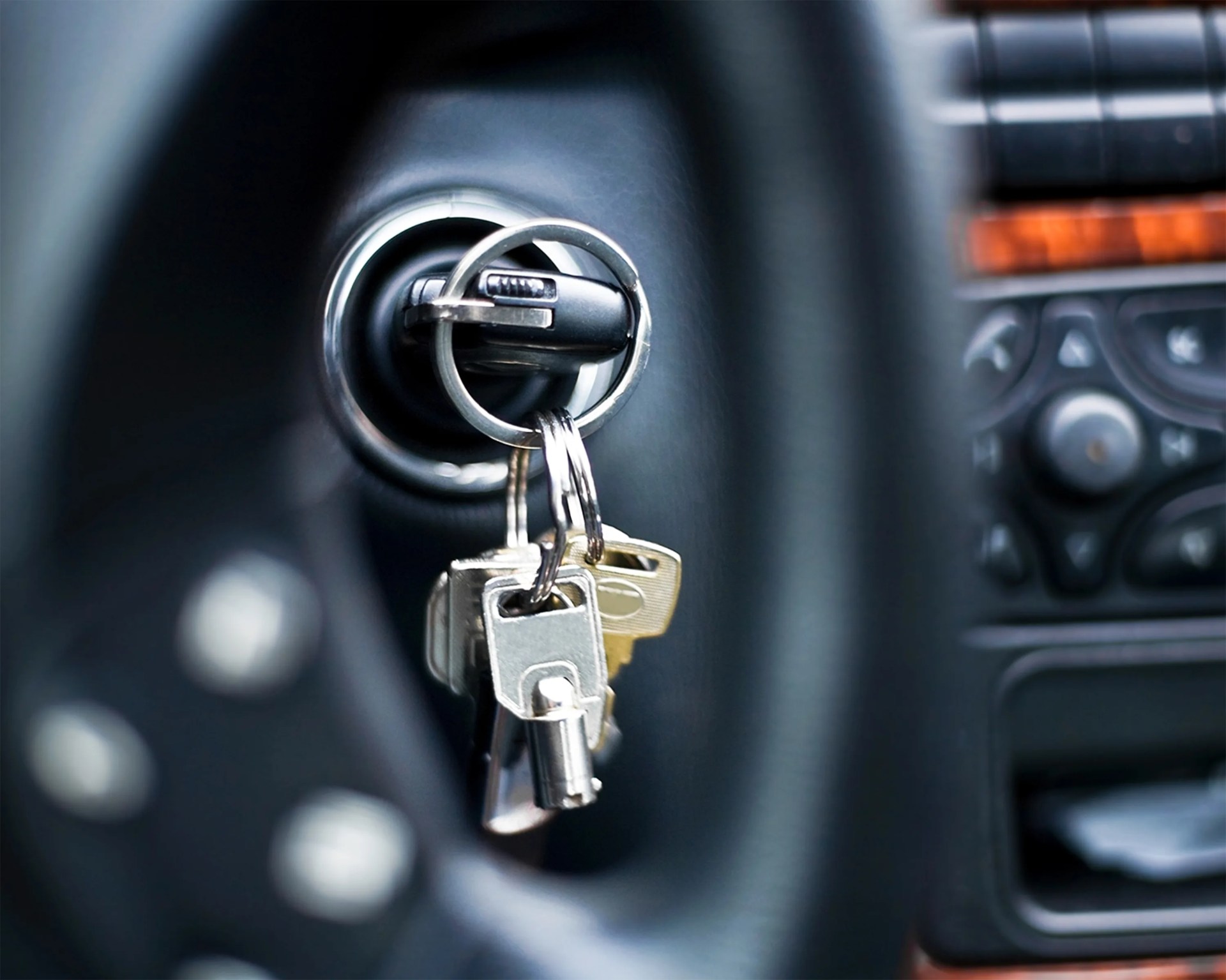 traditional car keys in the ignition of a car