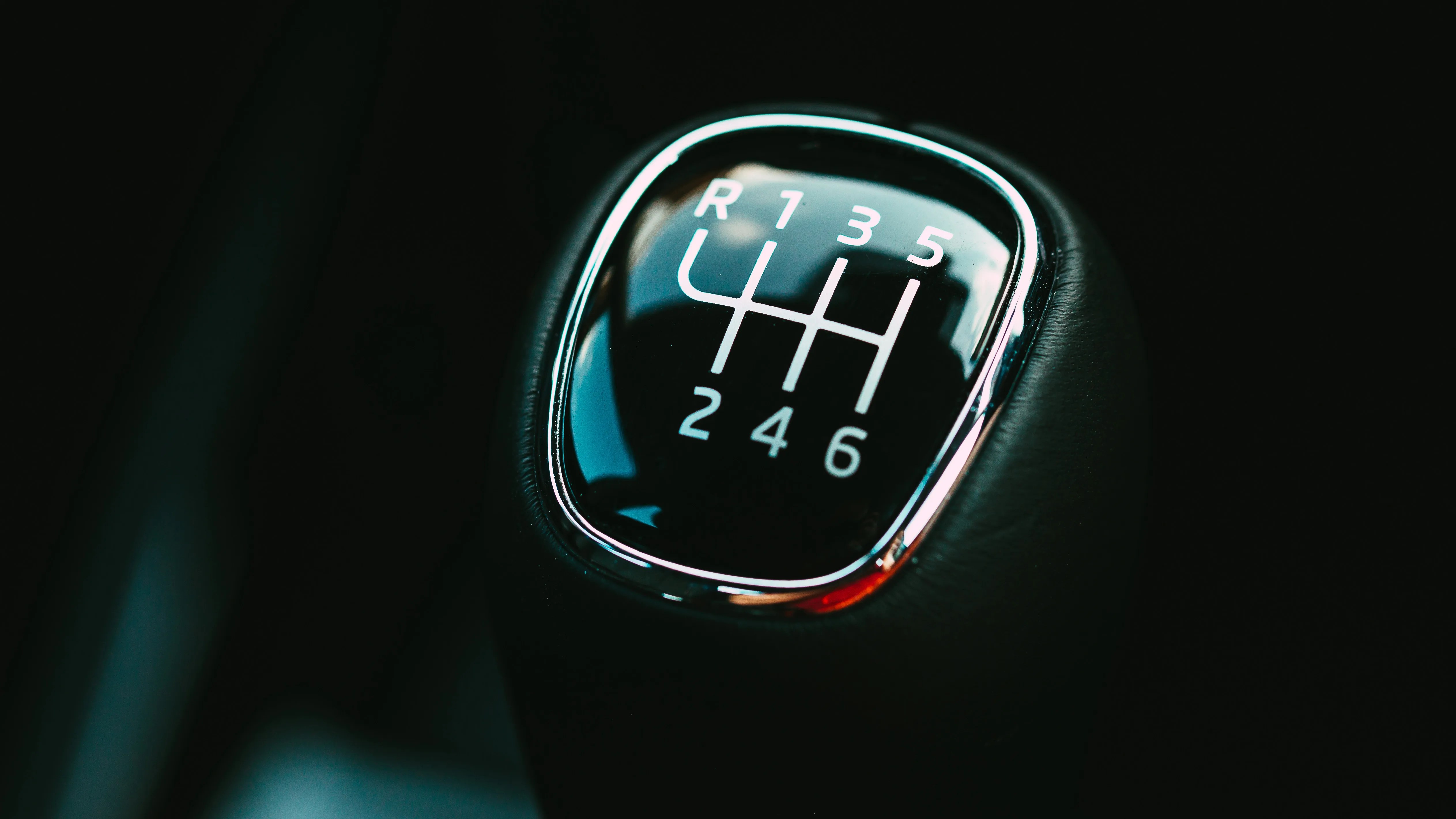 a close-up photo of the top of a manual transmission shifter