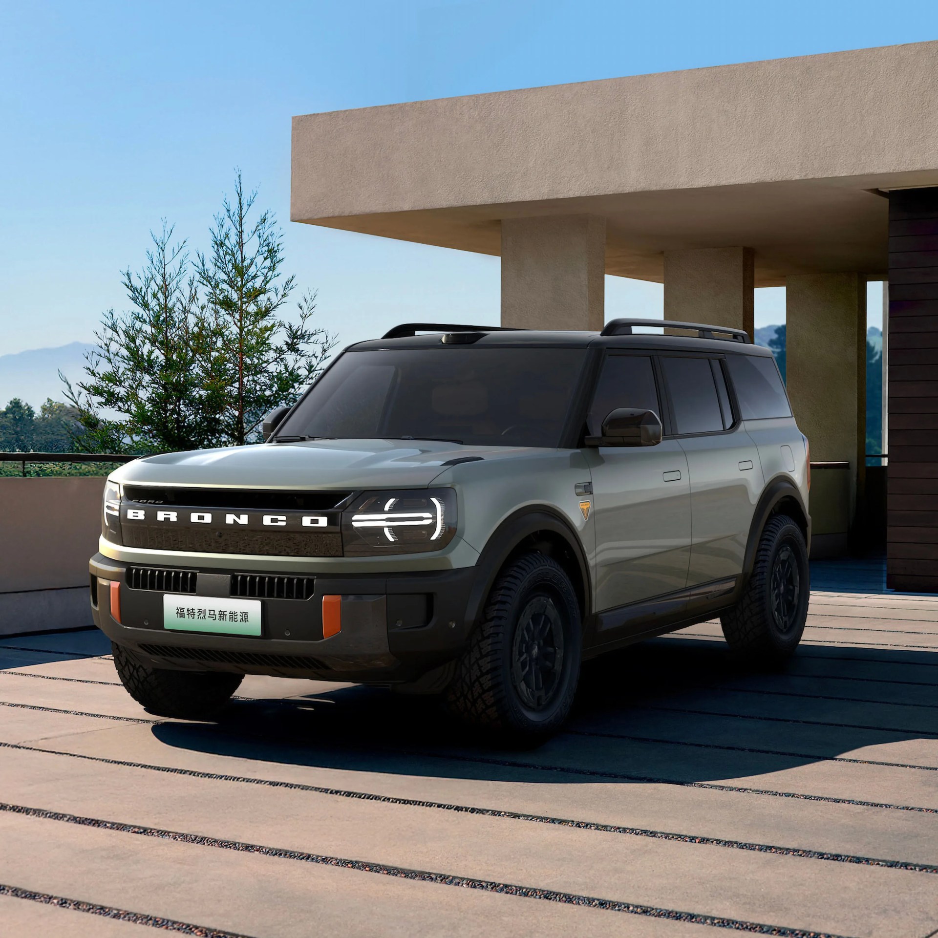 electric ford bronco parked in front of garage