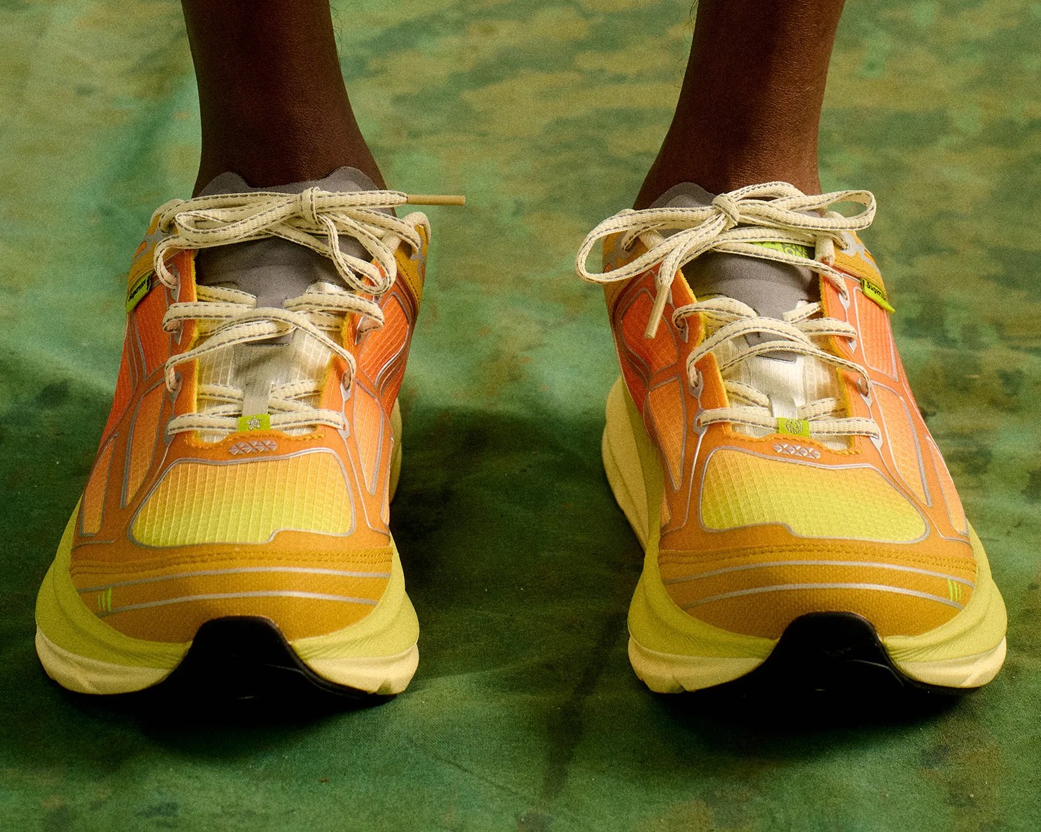 hoka x supervsn clifton one9 neon gold front