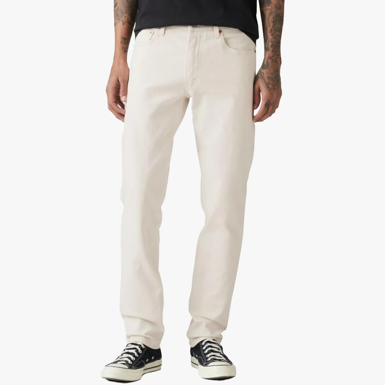 a man wearing white Levi's jeans