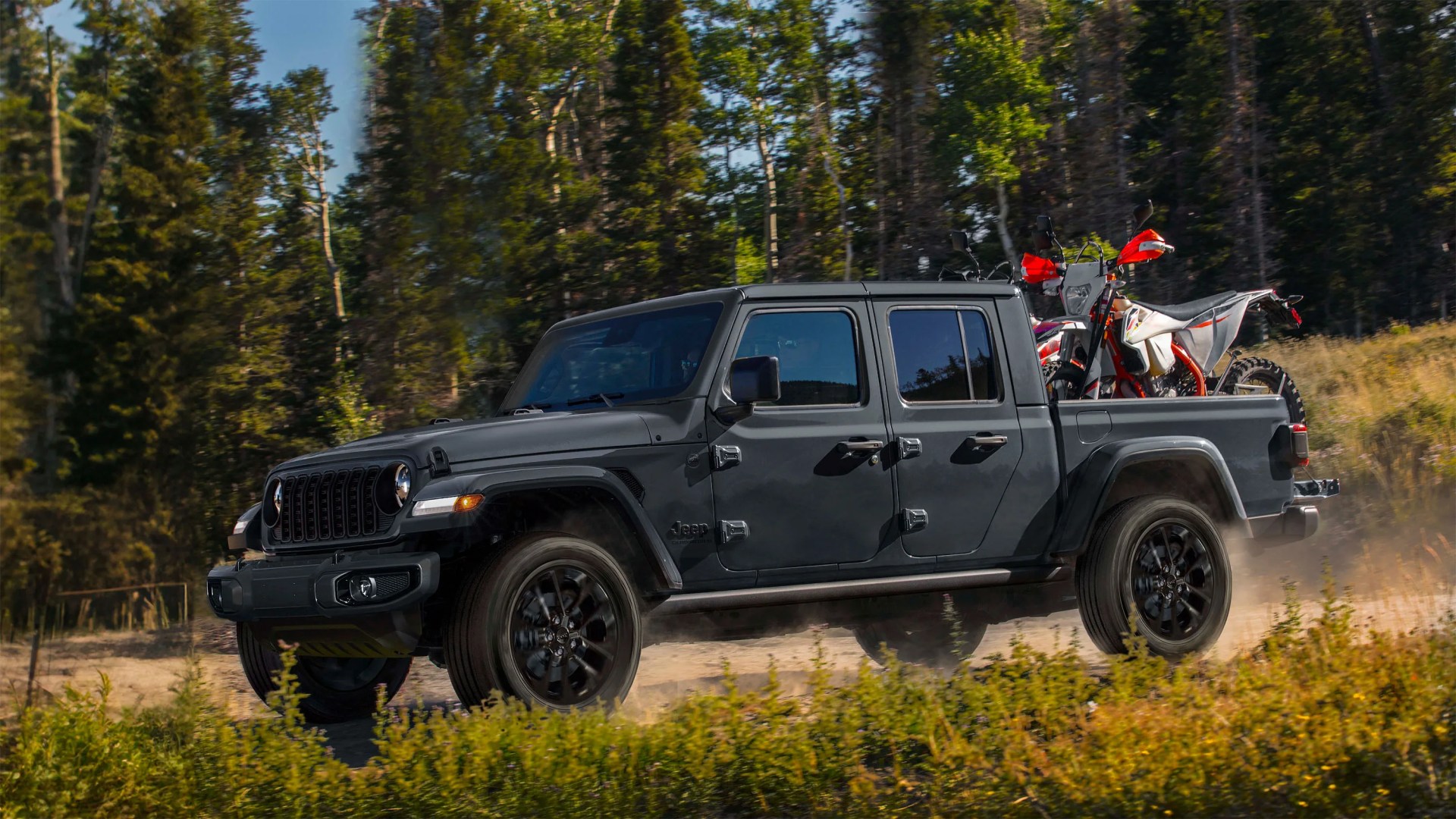 a gray jeep with a bike in truck bed