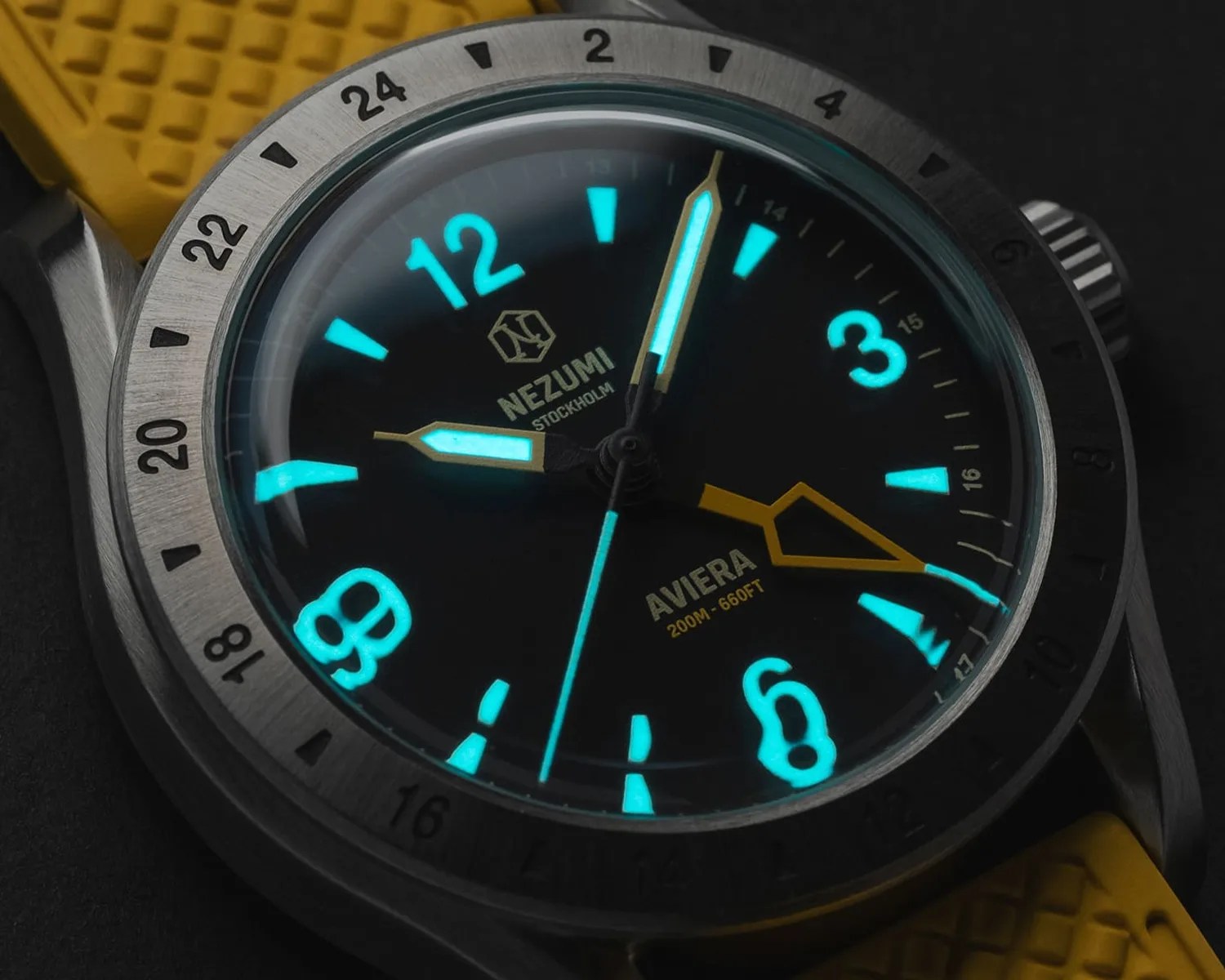 a nezumi gmt watch glowing in the dark