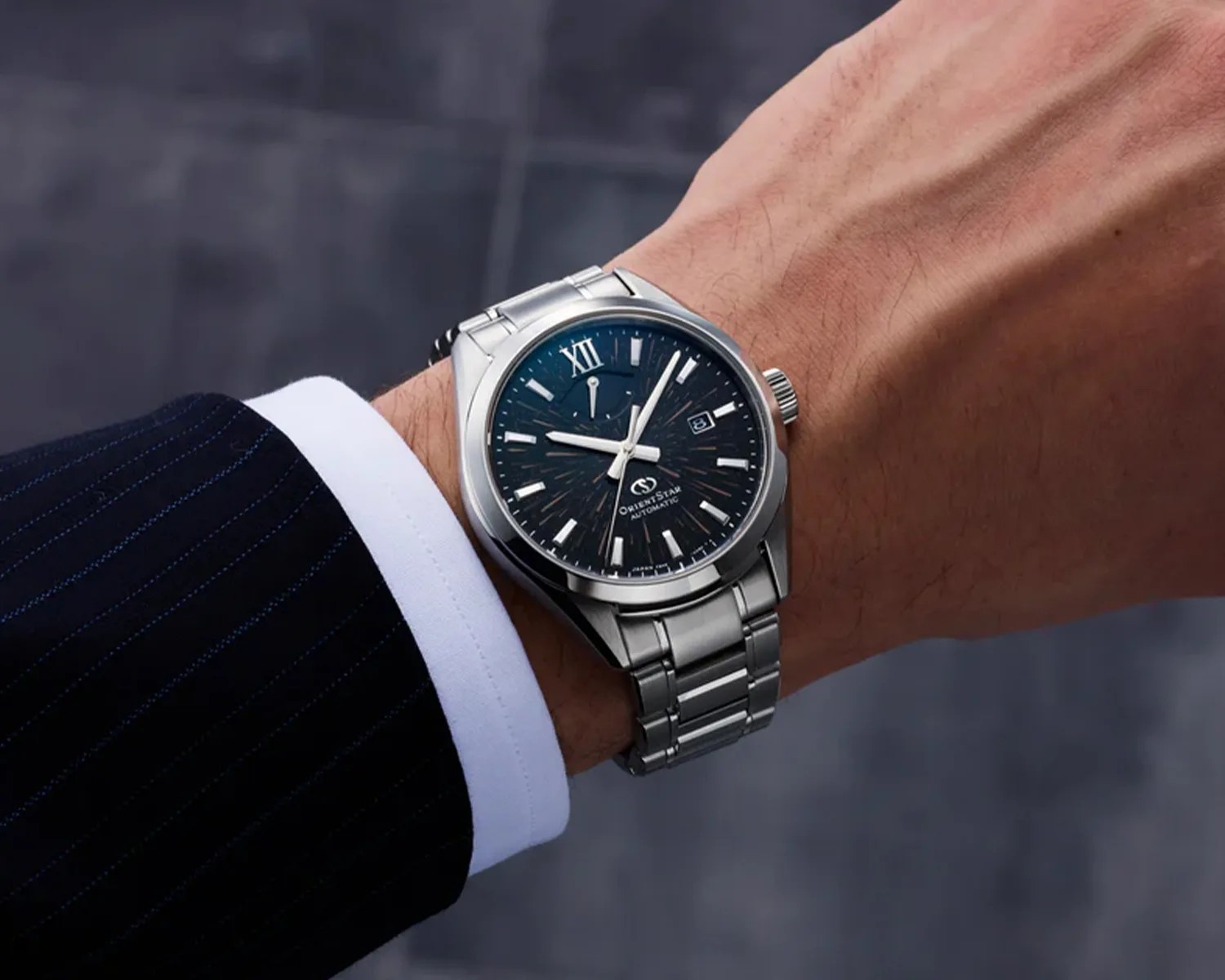 an orient star watch on a mans wrist