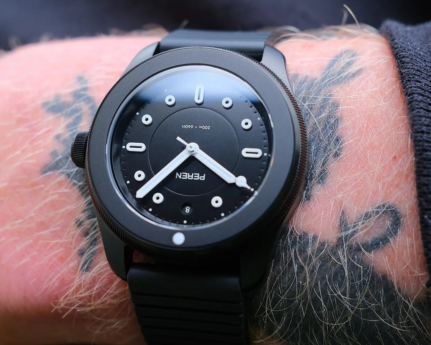 a peren dive watch on a mans wrist
