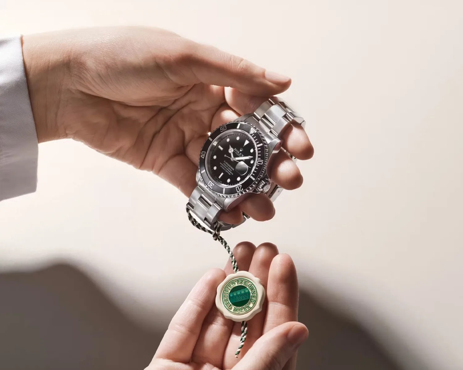 a man holds a rolex watch