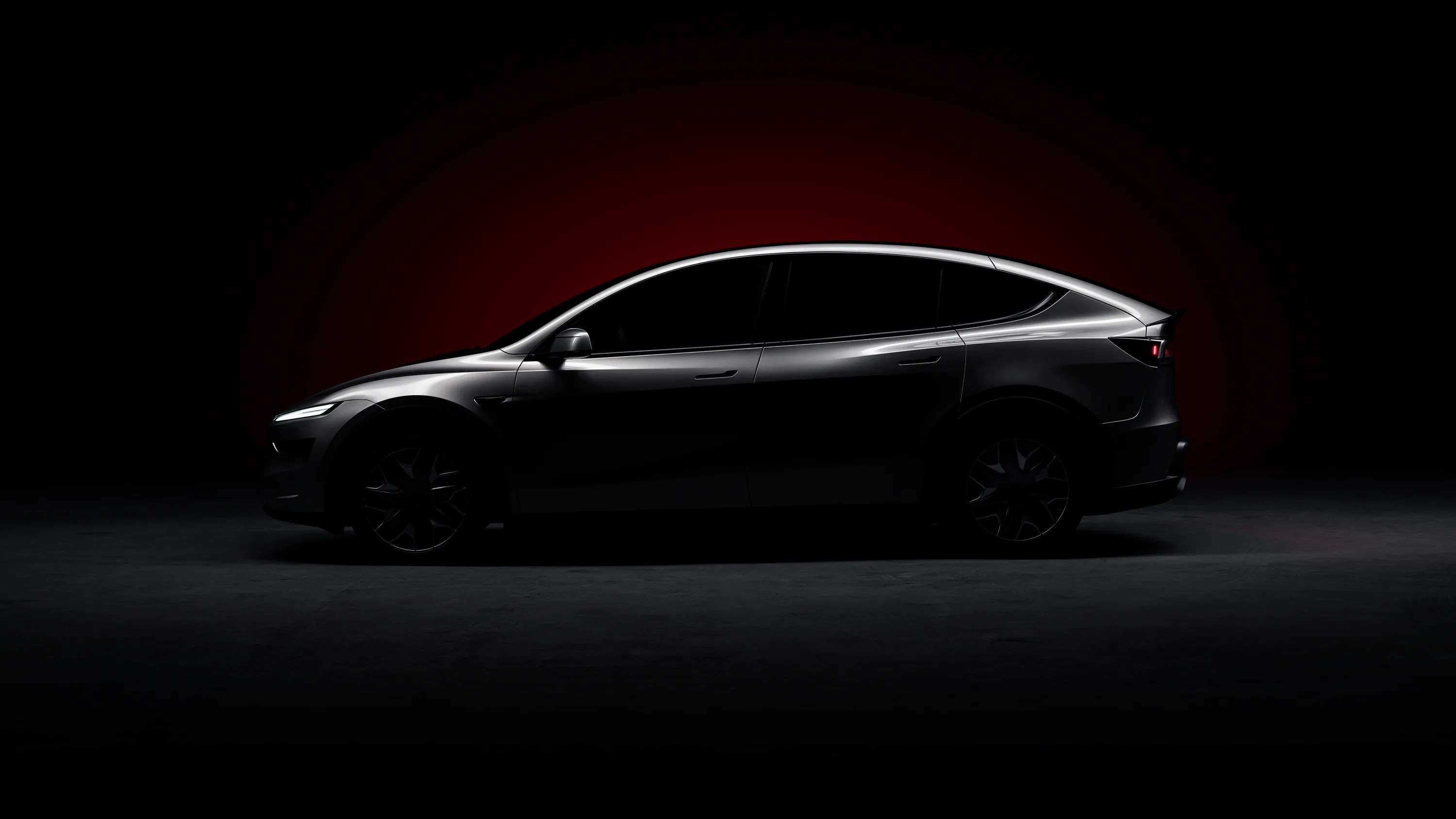 a tesla model yl in a dark studio setting