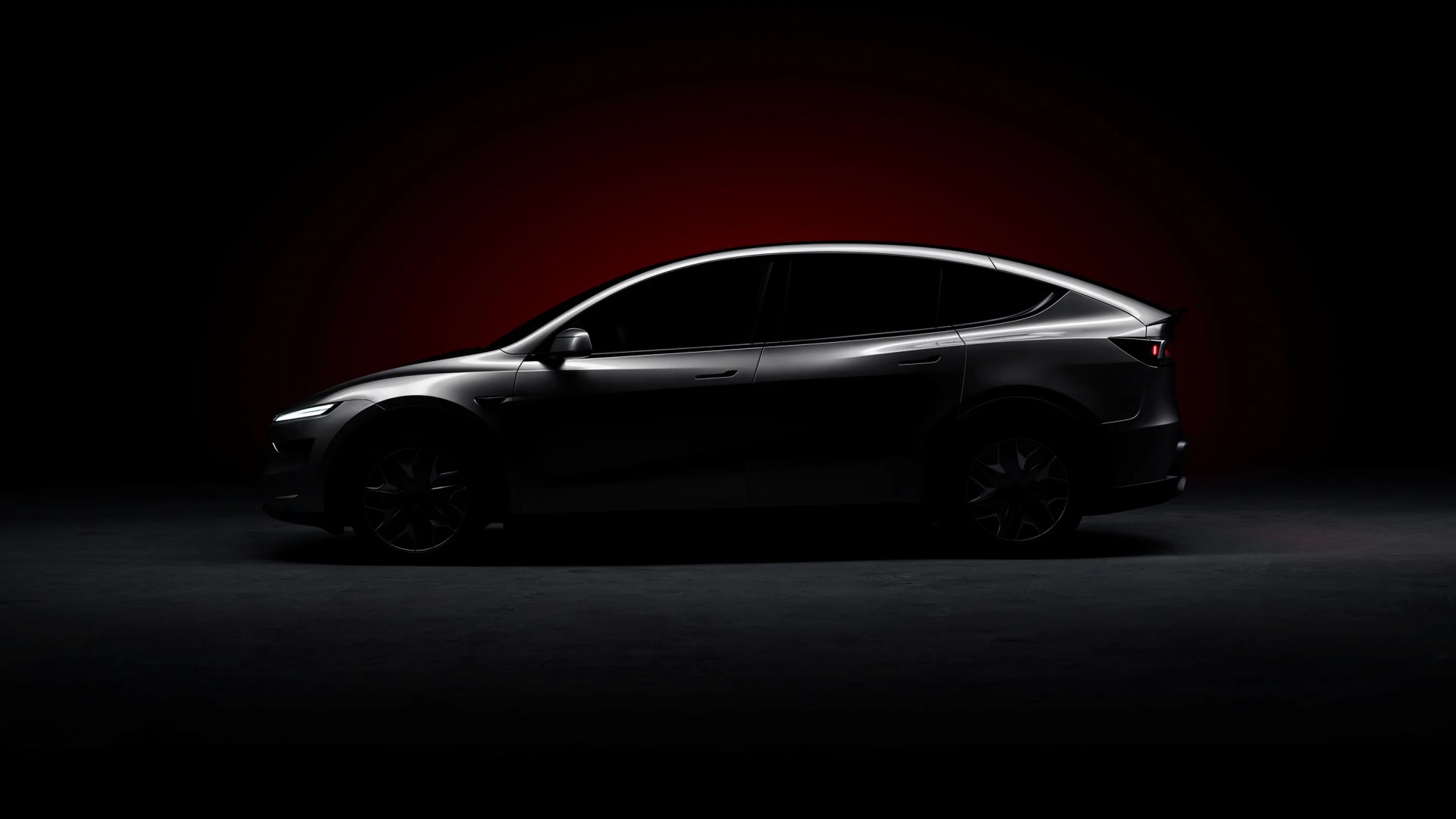 a tesla model yl in a dark studio setting