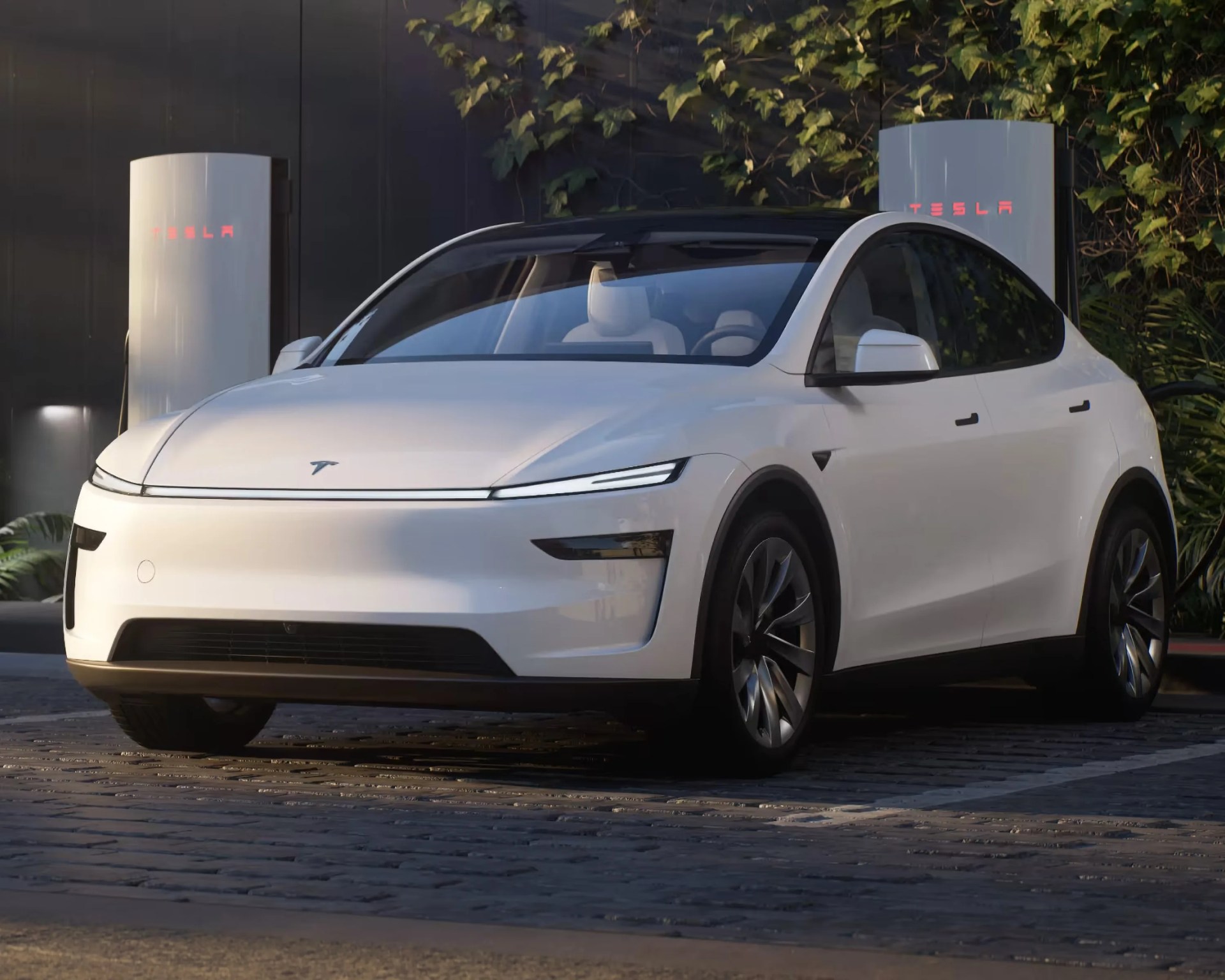 a white tesla model y charging