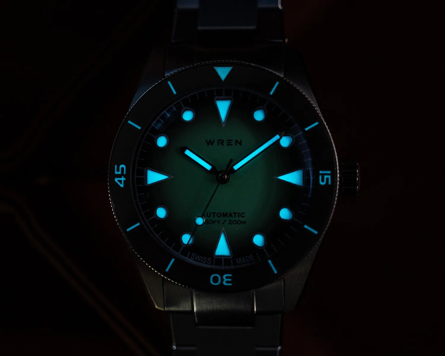 a wren dive watch glowing in the dark