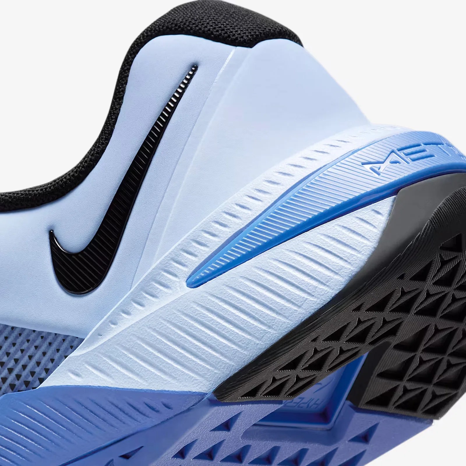 A close-up of the heel of a blue Nike Metcon 10 gym shoe