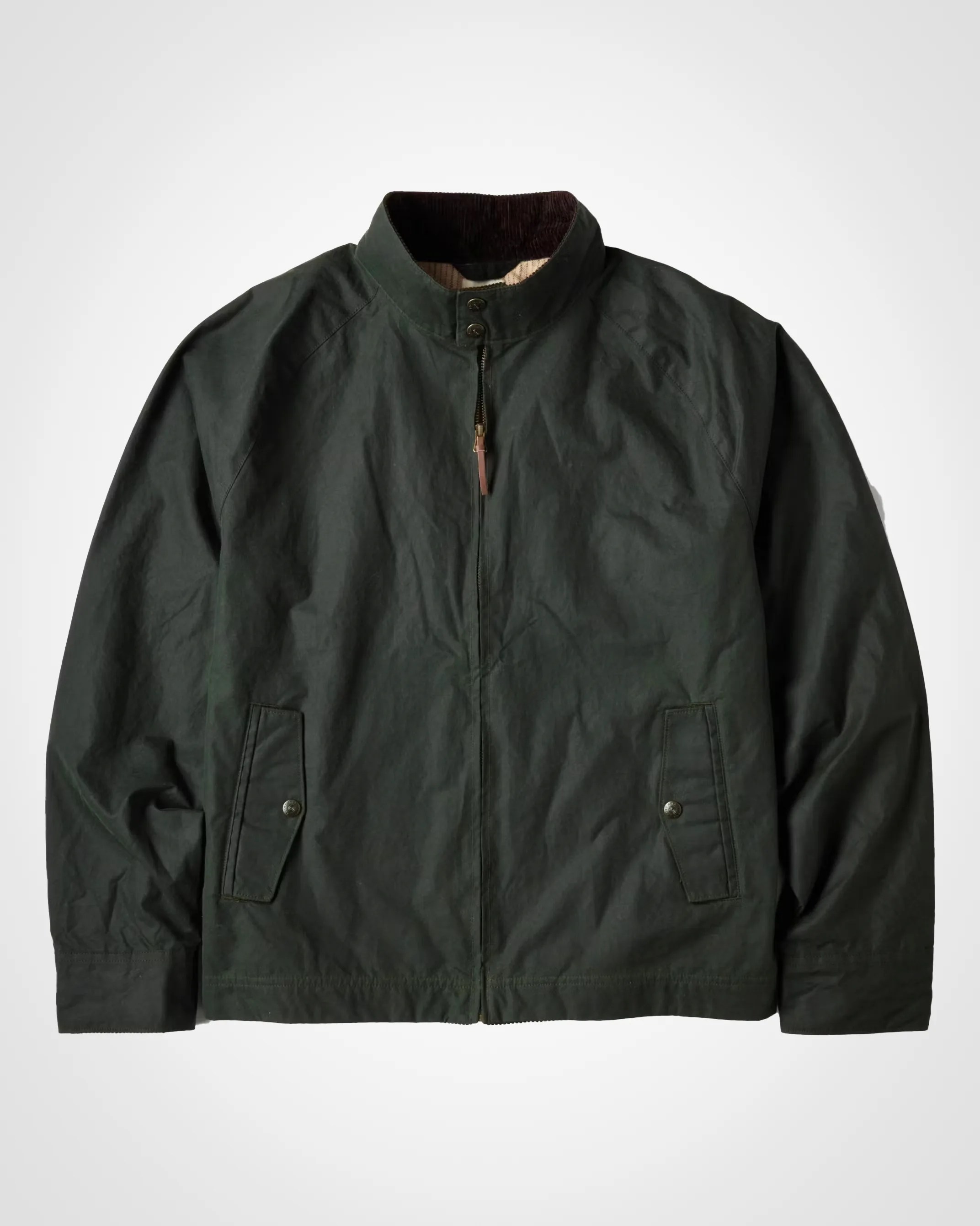 a green Flint and Tinder waxed harrington jacket