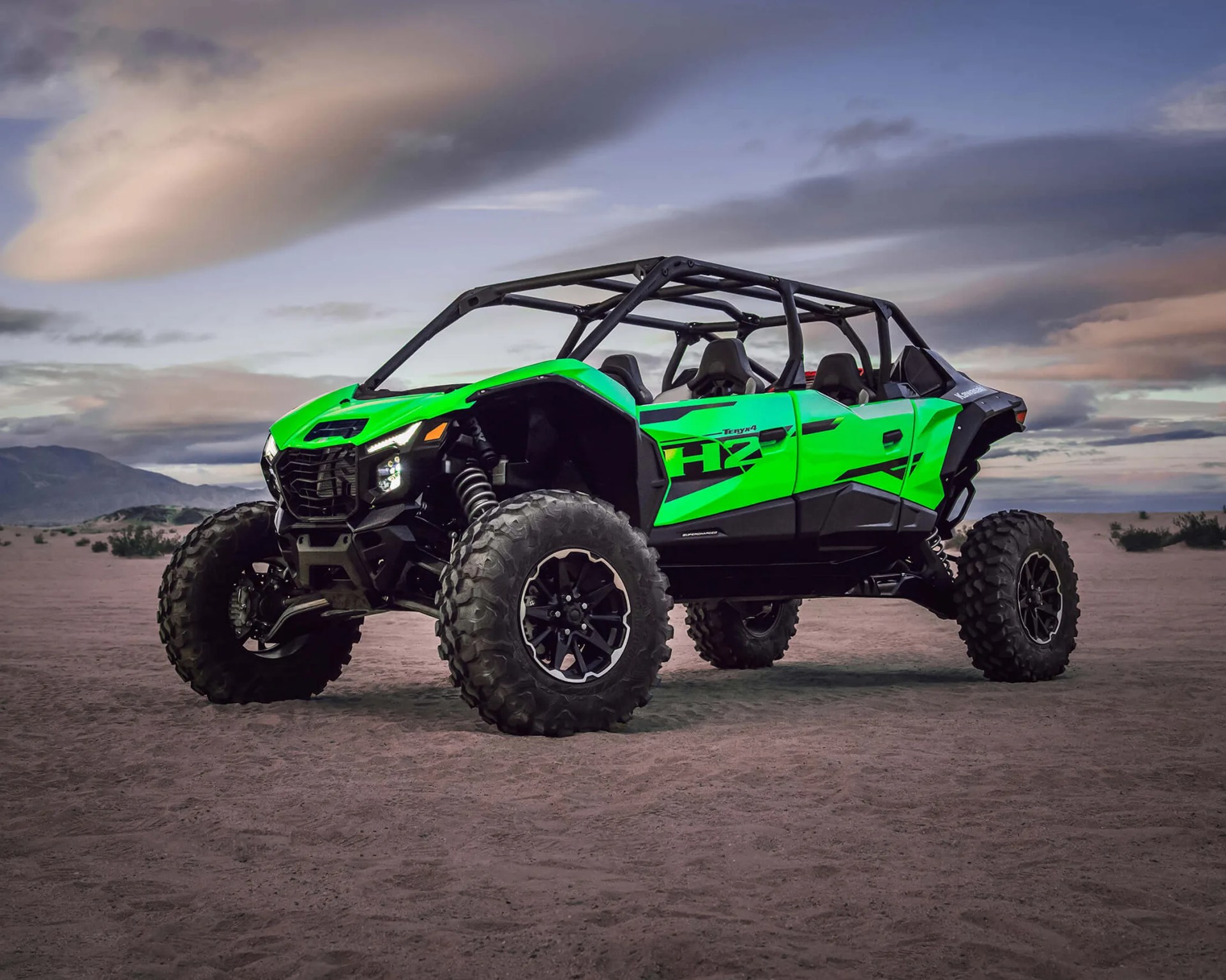 a photo of a green kawasaki UTV parked
